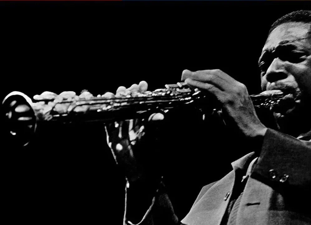 Detail, album cover, Impressions (Impulse Records, 1963). Features black and white photo of John Coltrane playing the soprano sax. Coltrane's modal jazz was an influence on the Grateful Dead's early years