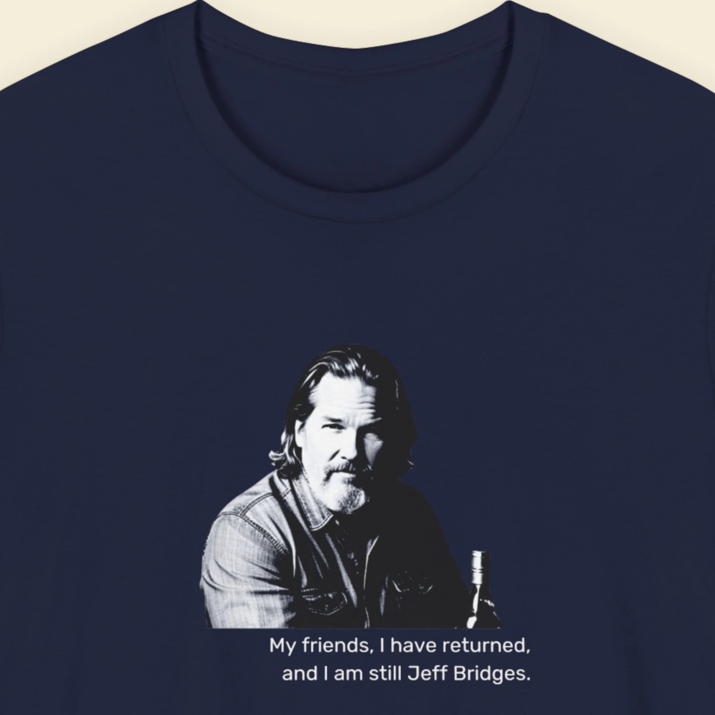 Navy blue t-shirt with humorous colorful text on a beige background featuring an image of iconic hollywood star Jeff Bridges offering one of his famous quotes.