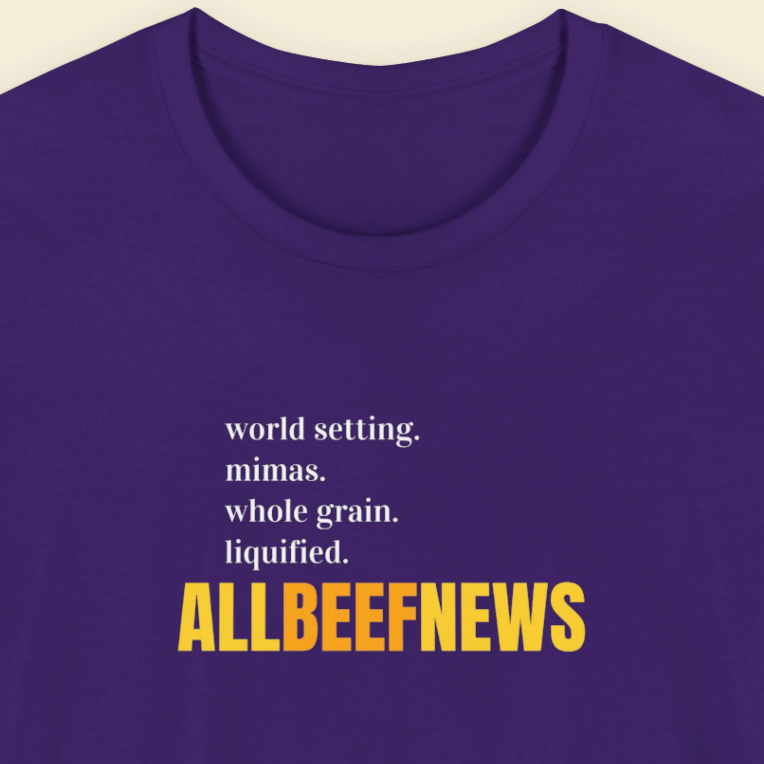 Navy blue t-shirt with humorous colorful text on a beige background.