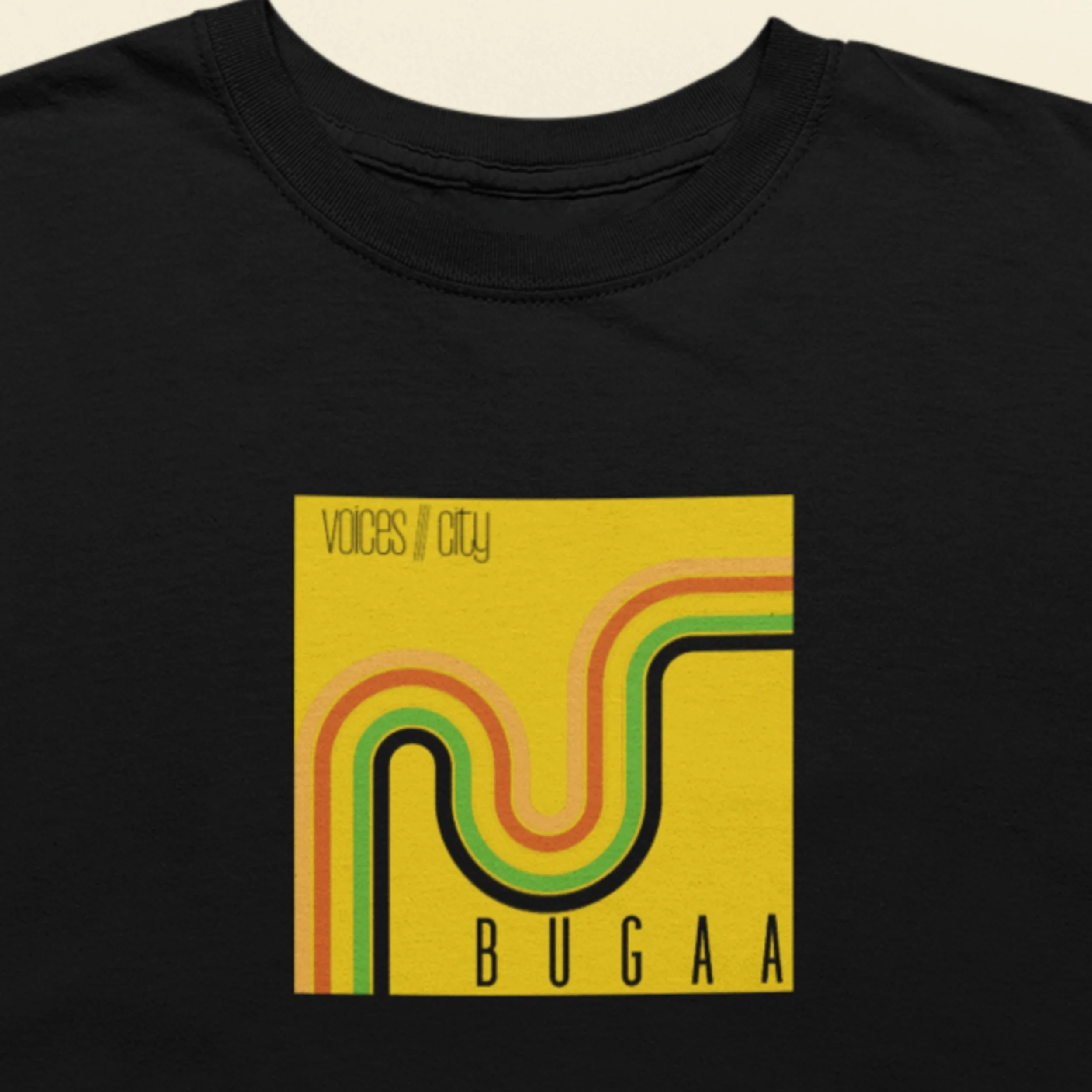 A closeup of a black t-shirt featuring an image of the album cover from BUGAA titled Voices///City.