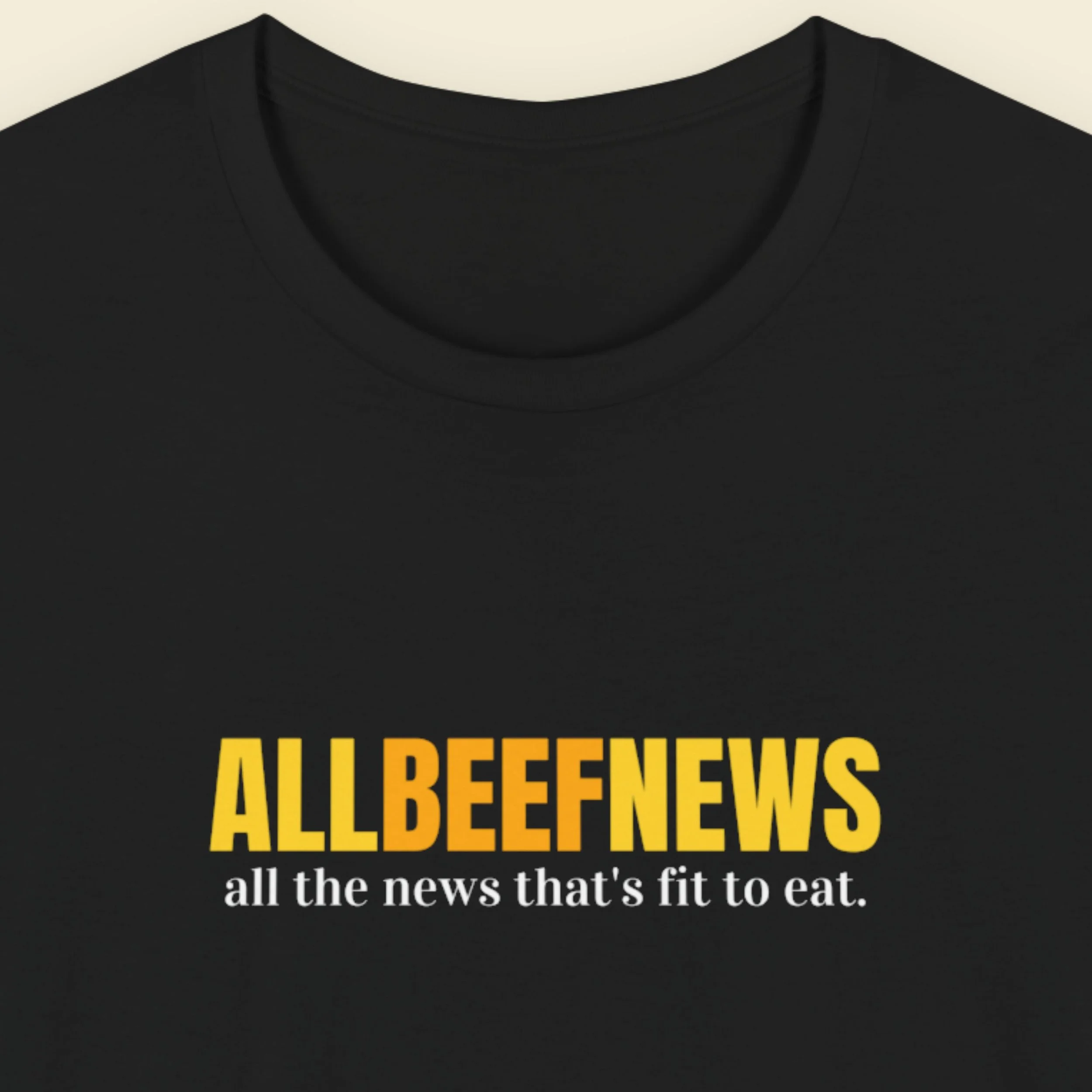 Black t-shirt with humorous colorful text on a beige background.