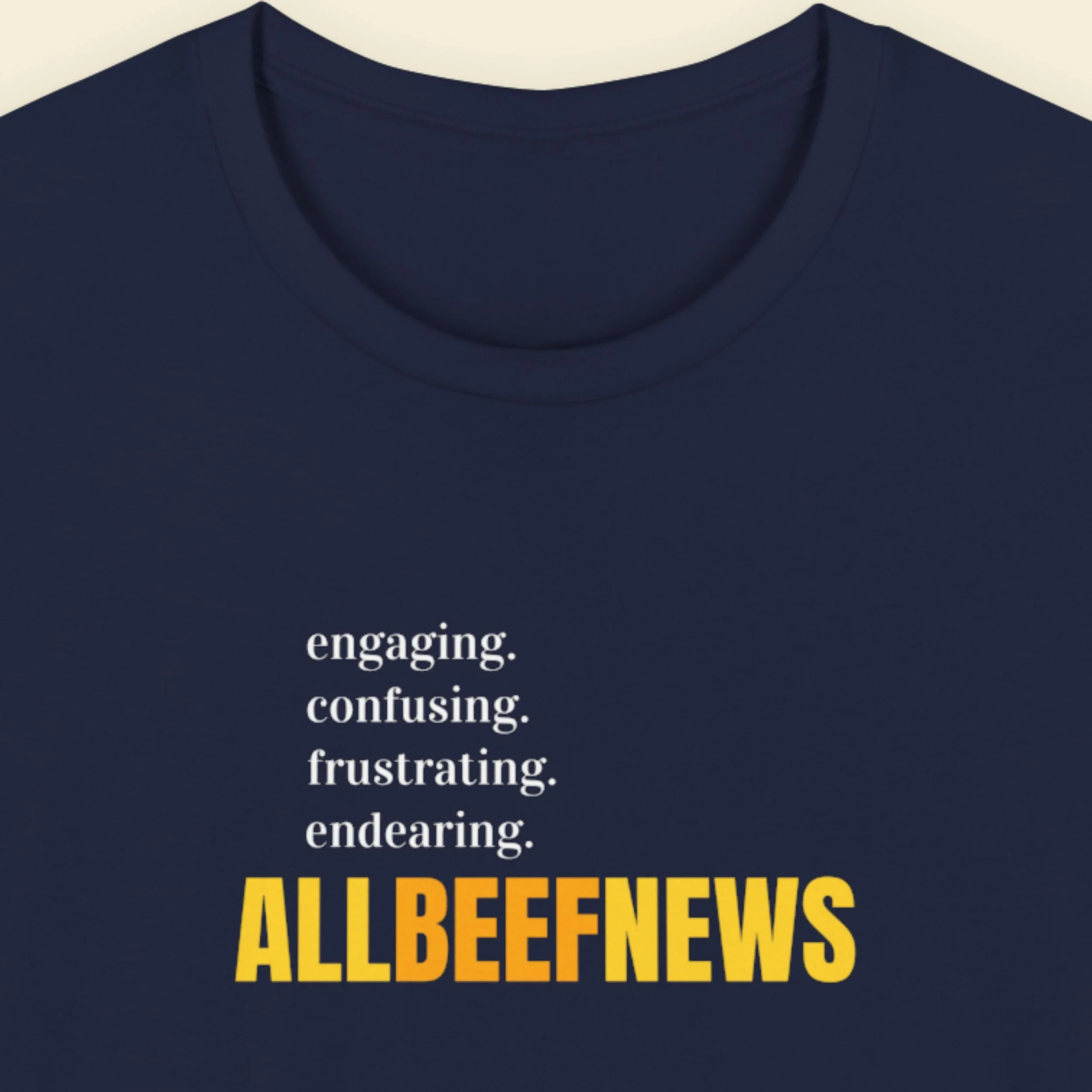Navy blue t-shirt with humorous nonsensical colorful text on a beige background.