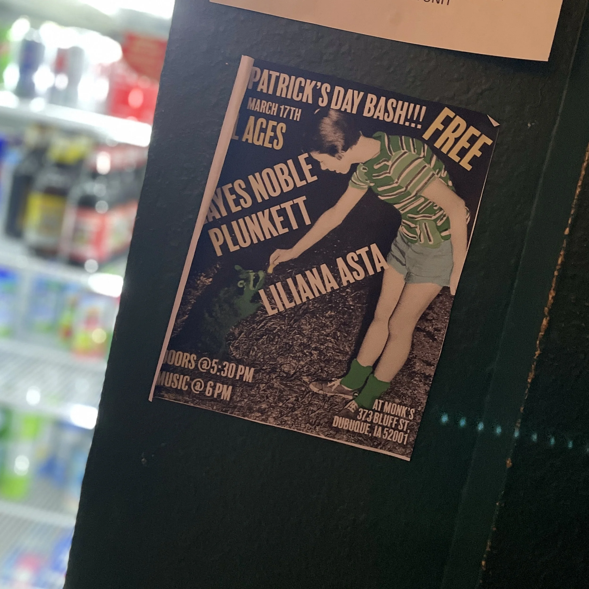 Poster for a St. Patrick's Day event featuring a young boy in a striped green shirt and shorts, touching a small frog on the ground. The poster includes event details and a location in Dubuque, Iowa.