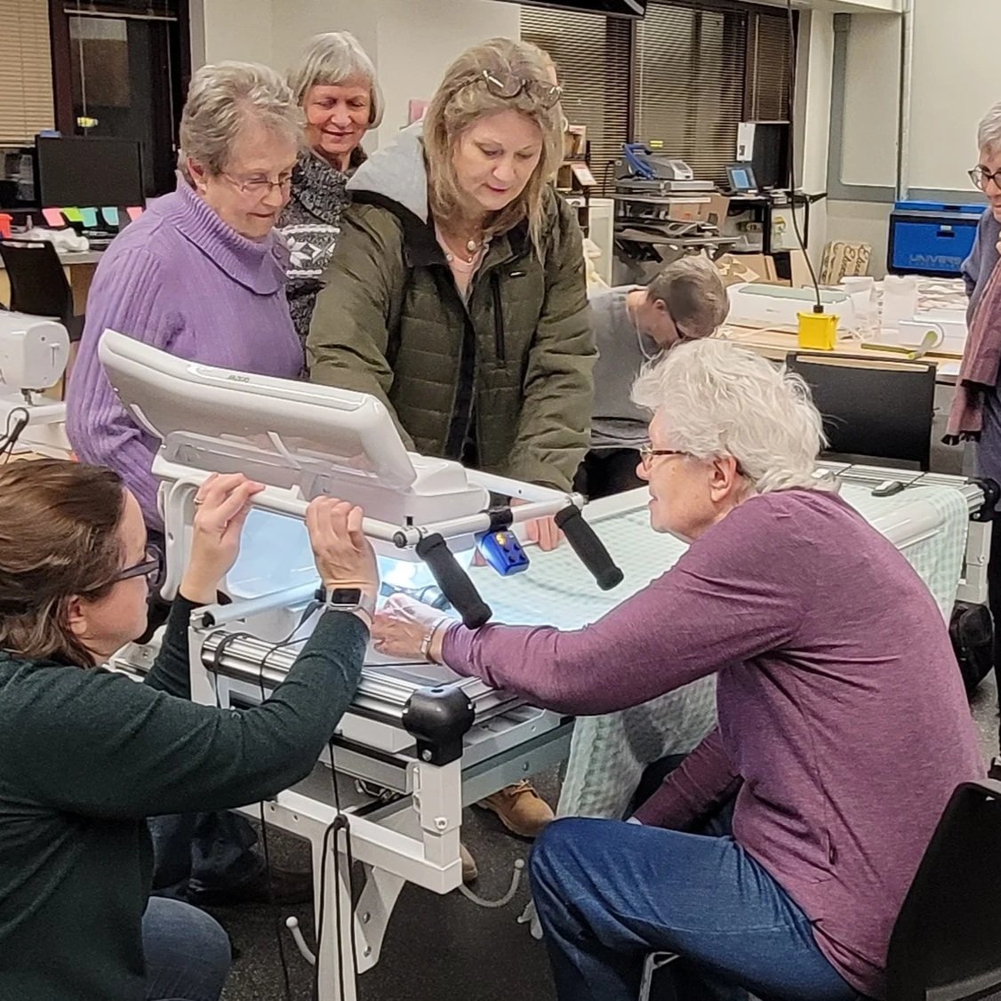 group photo at a quilting machine learning for freedom quilt community project
