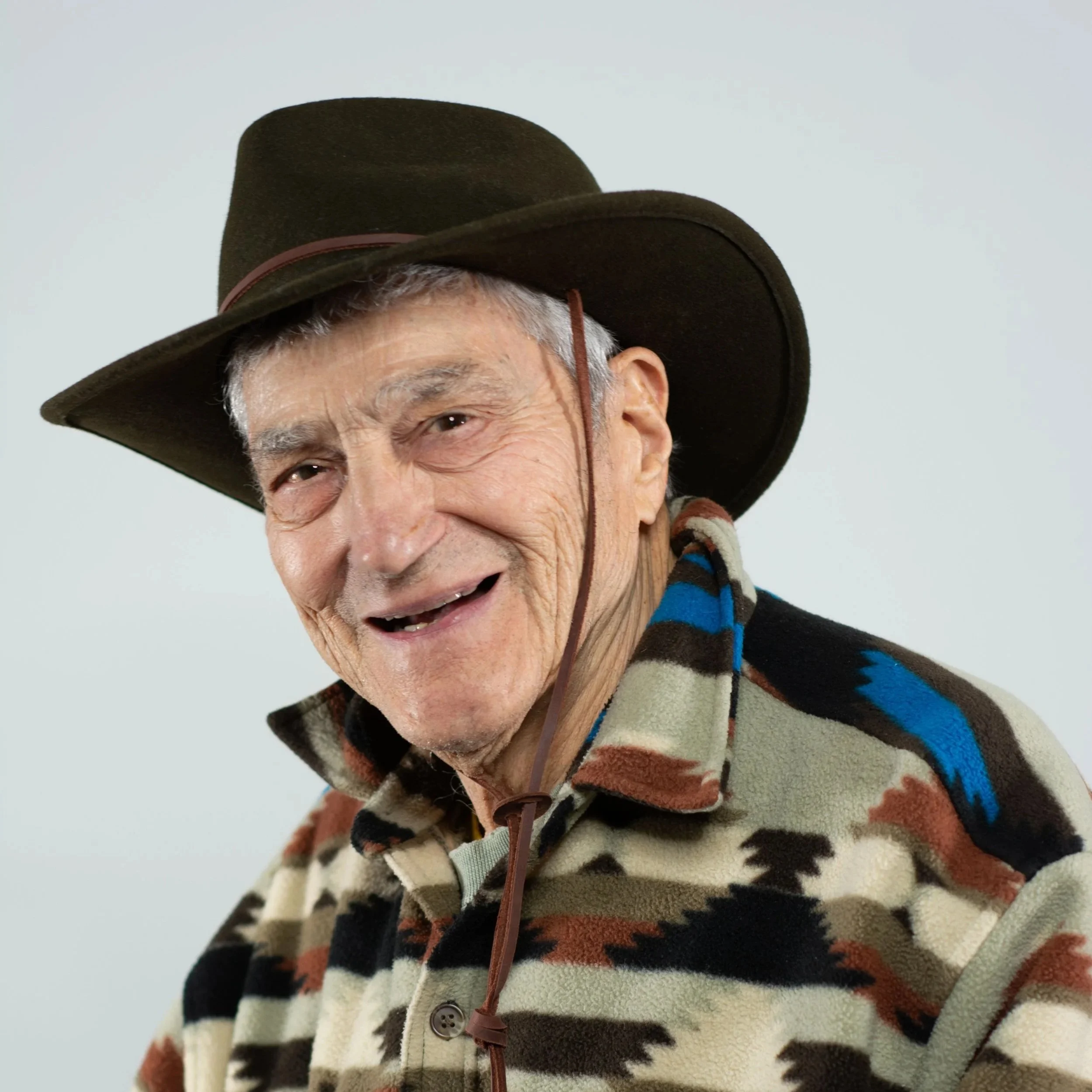 Man with a cowboy hat on getting professional headshot taken as a community program
