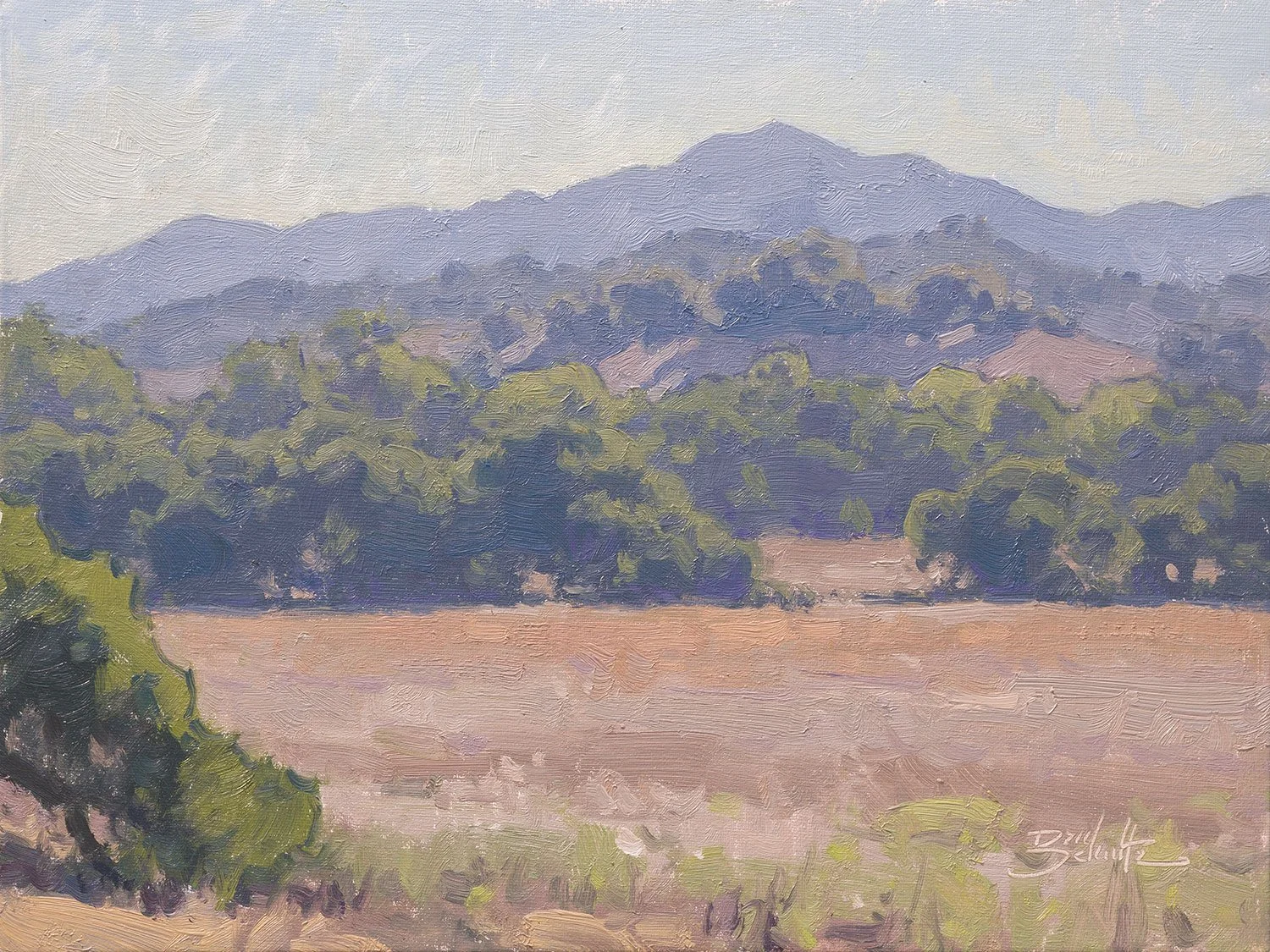 Painting of a mountain landscape with distant blue mountains, forested hills in the middle ground, and a sunny, open field in the foreground, signed by the artist in the bottom right corner.
