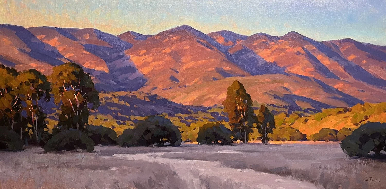 Painting of a mountain landscape at sunset with purple and orange hues on the mountains, green trees in the foreground, and a clear sky.