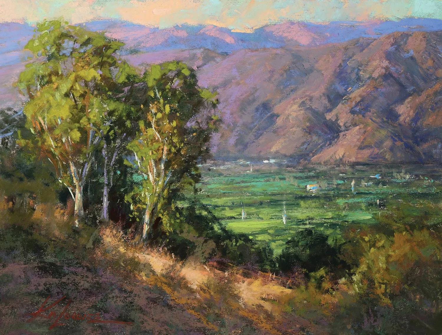 A landscape painting of green trees in the foreground with a valley and mountains in the background, under a colorful sky.