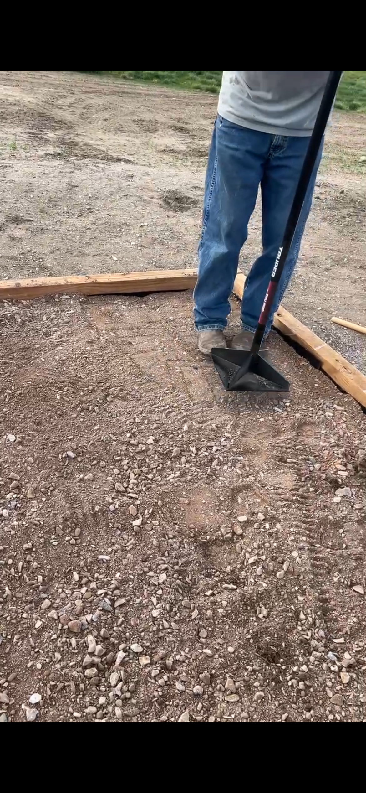 Base aggregate is spread with shovels and rakes, then hand tamped for compaction