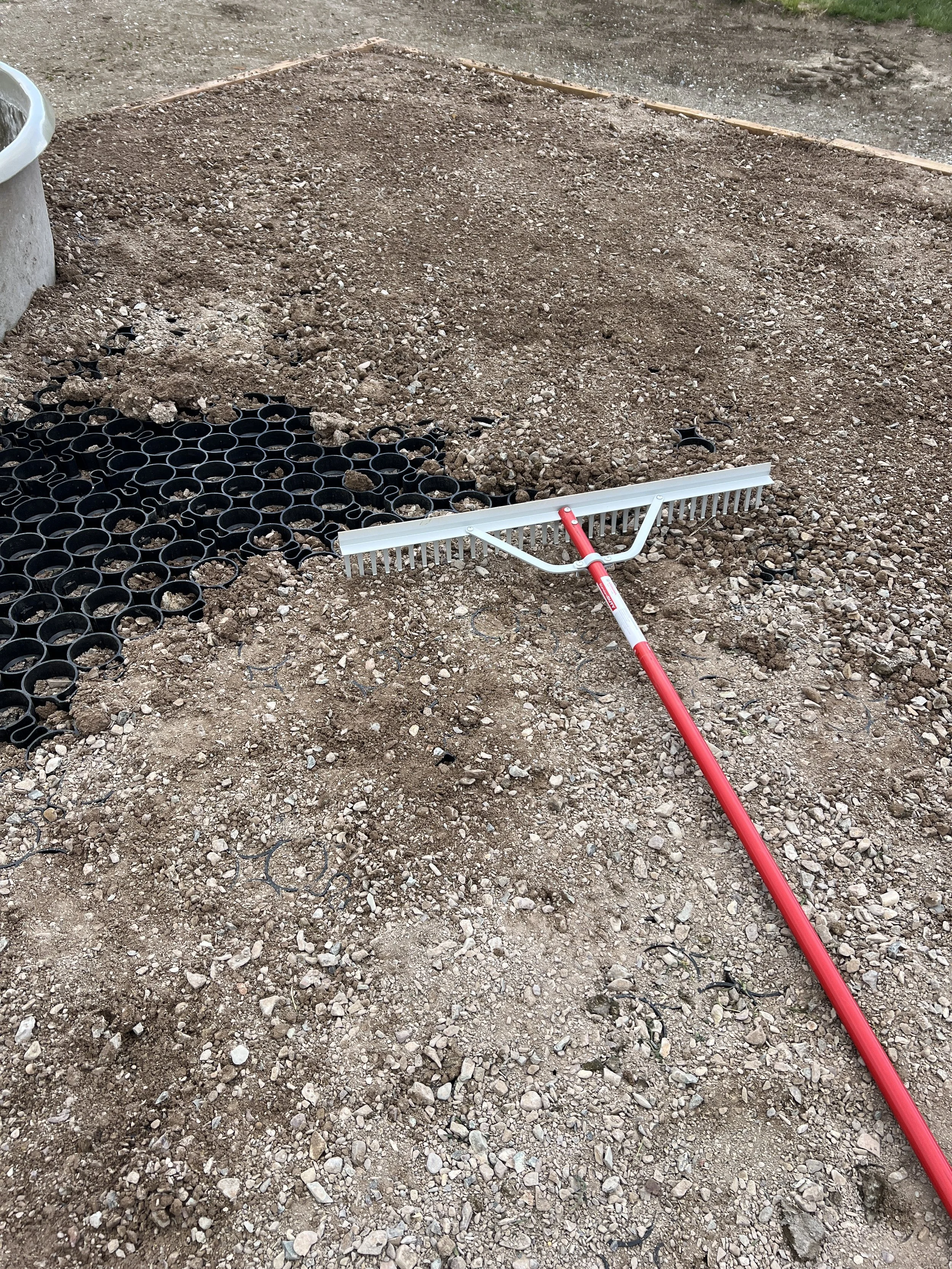 Rakes move and settle the aggregate into cells