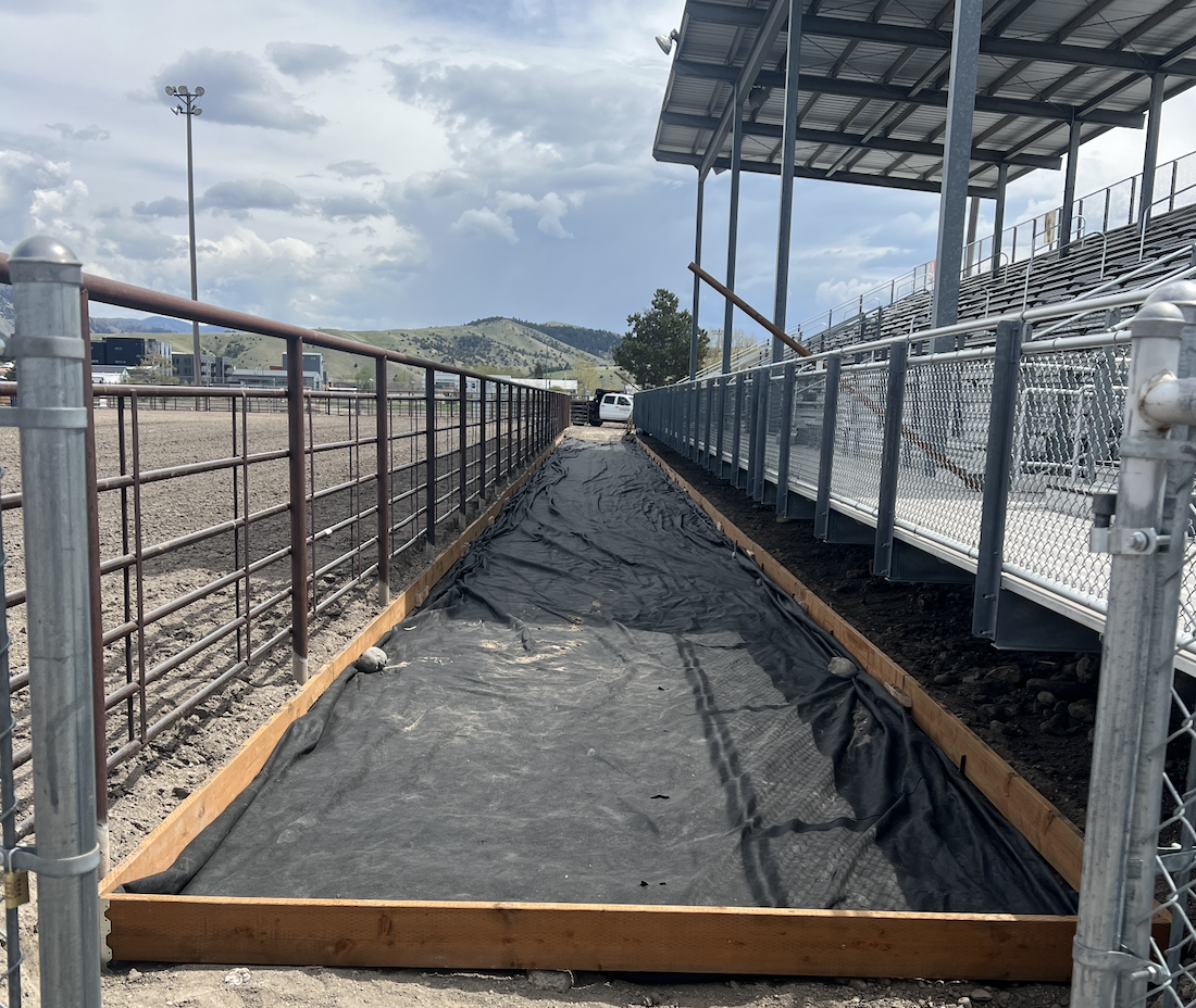 Non-woven fabric is laid and stapled to separate the organic material from the TrueGrid natural filtration system