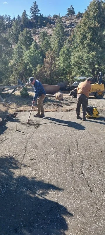 A crew member continued to fill the cells while another crew member used a plate compactor to further compact the infill material