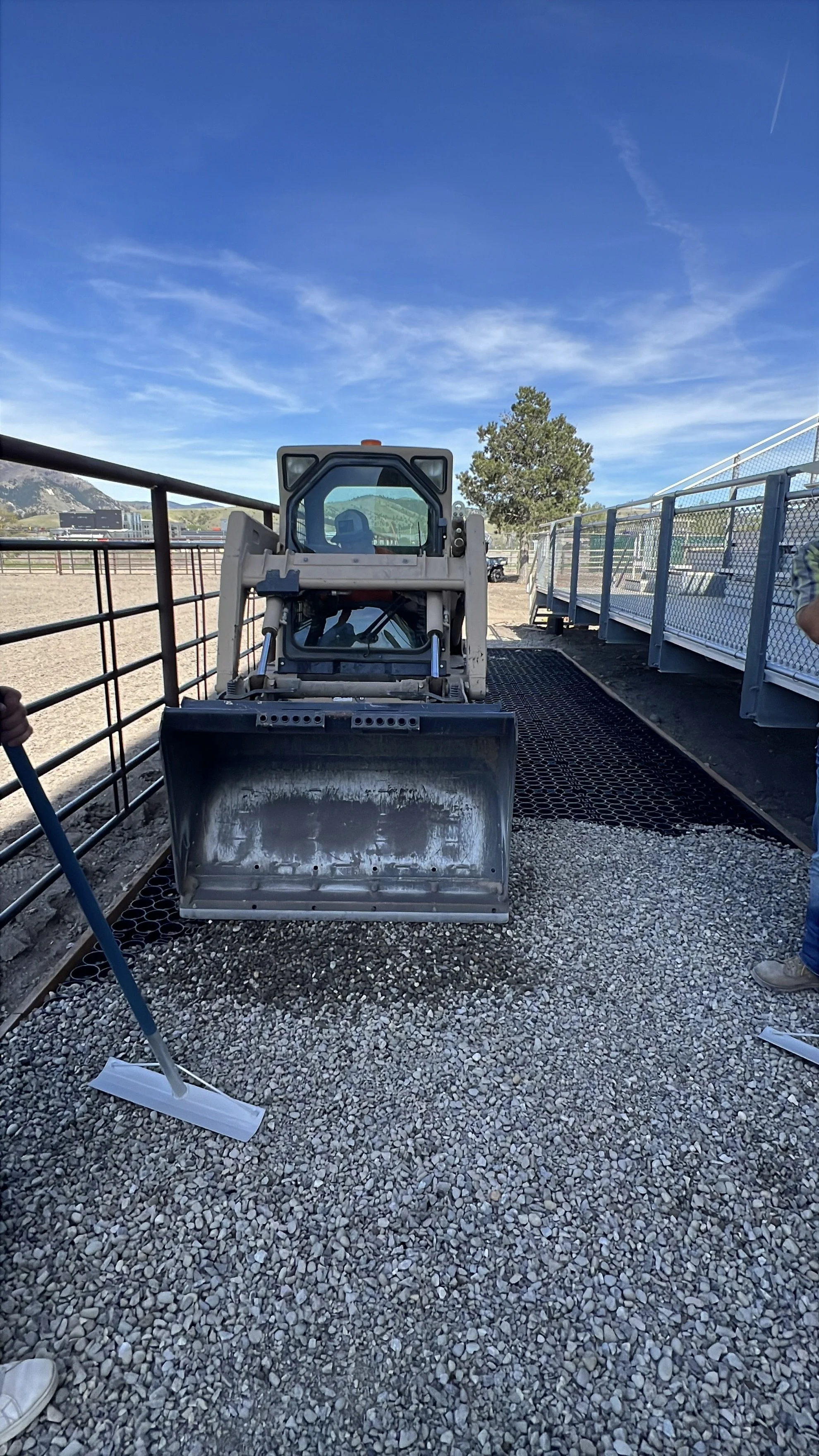 3/4 inch crush aggregate is brought in by skid steer, dumped, and back-dragged to fill the TrueGrid cells 