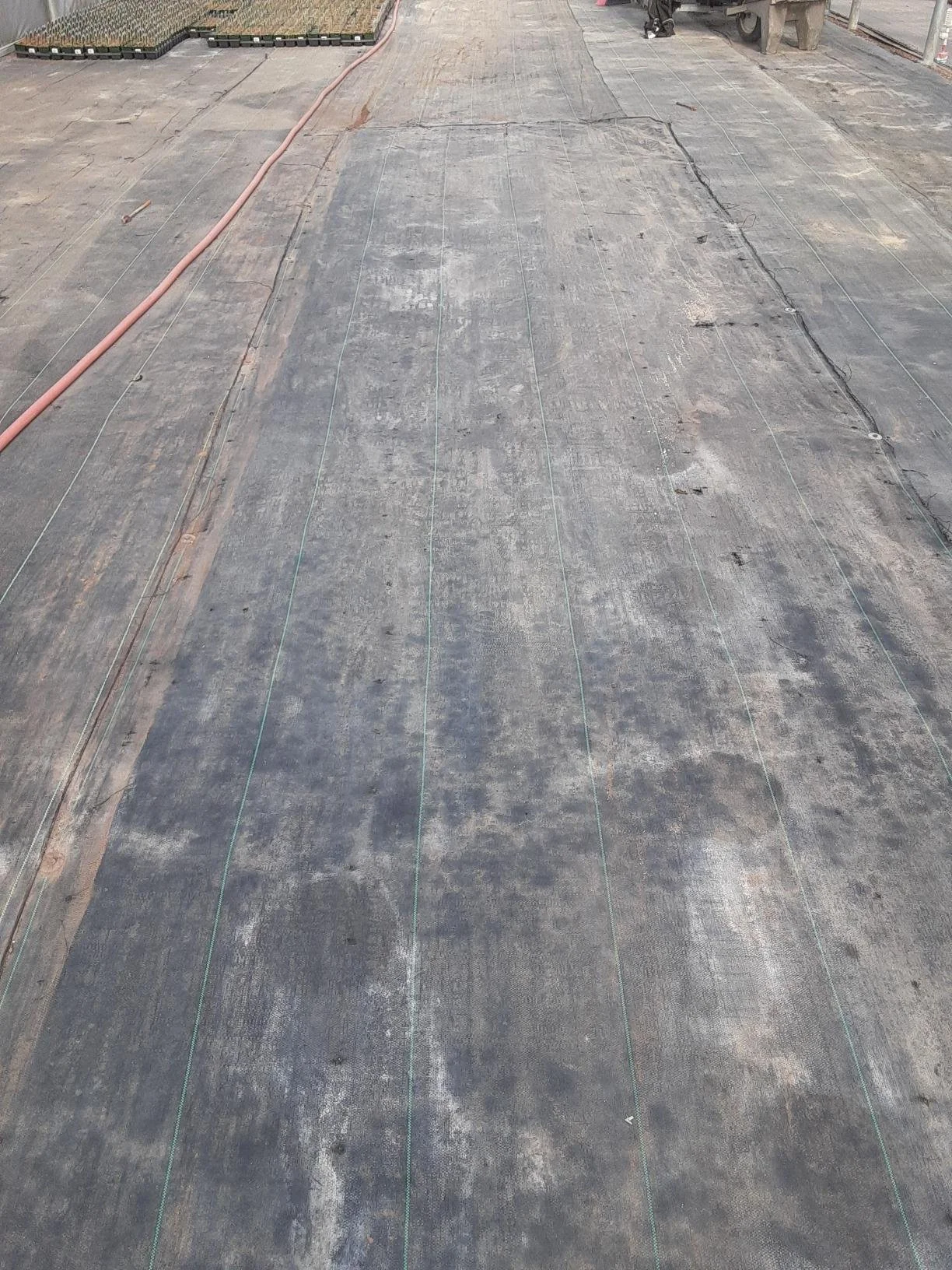 Weedmat is secured over the TrueGrid aisle for consistency with the rest of the floor