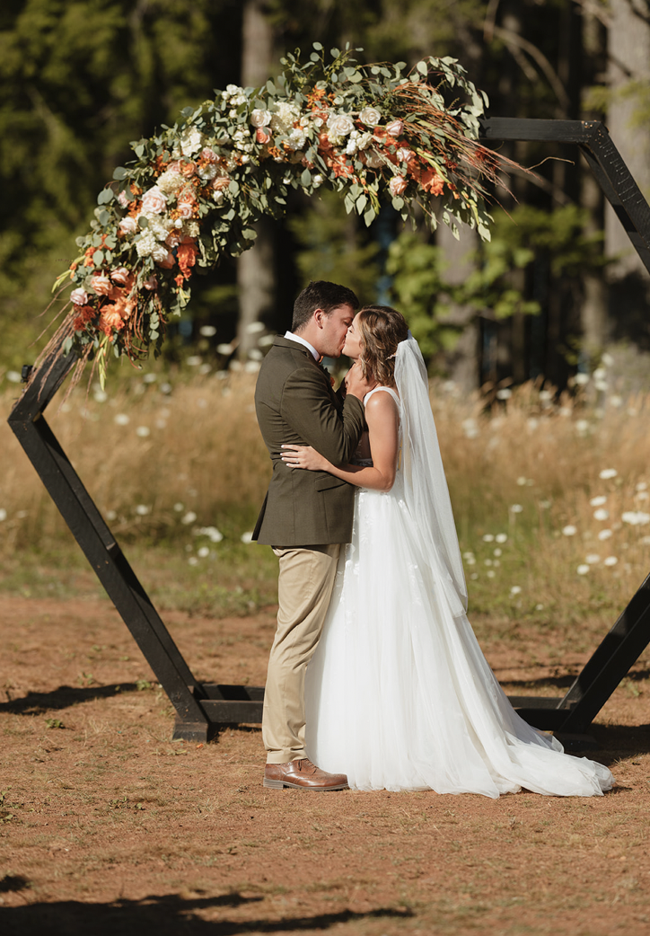 Laurie’s customers, Fernando and Kate embracing by the lake on their wedding day.