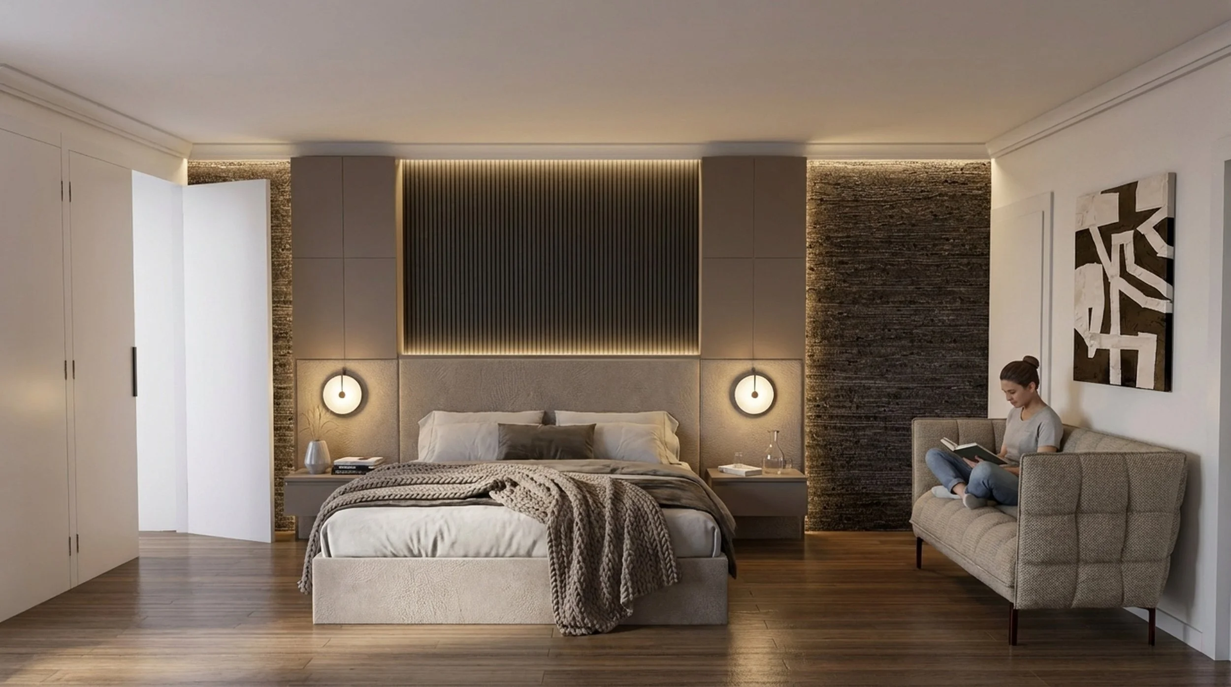 Modern bedroom with a bed, nightstands, and wall sconces, with a woman sitting on a beige couch reading a book.