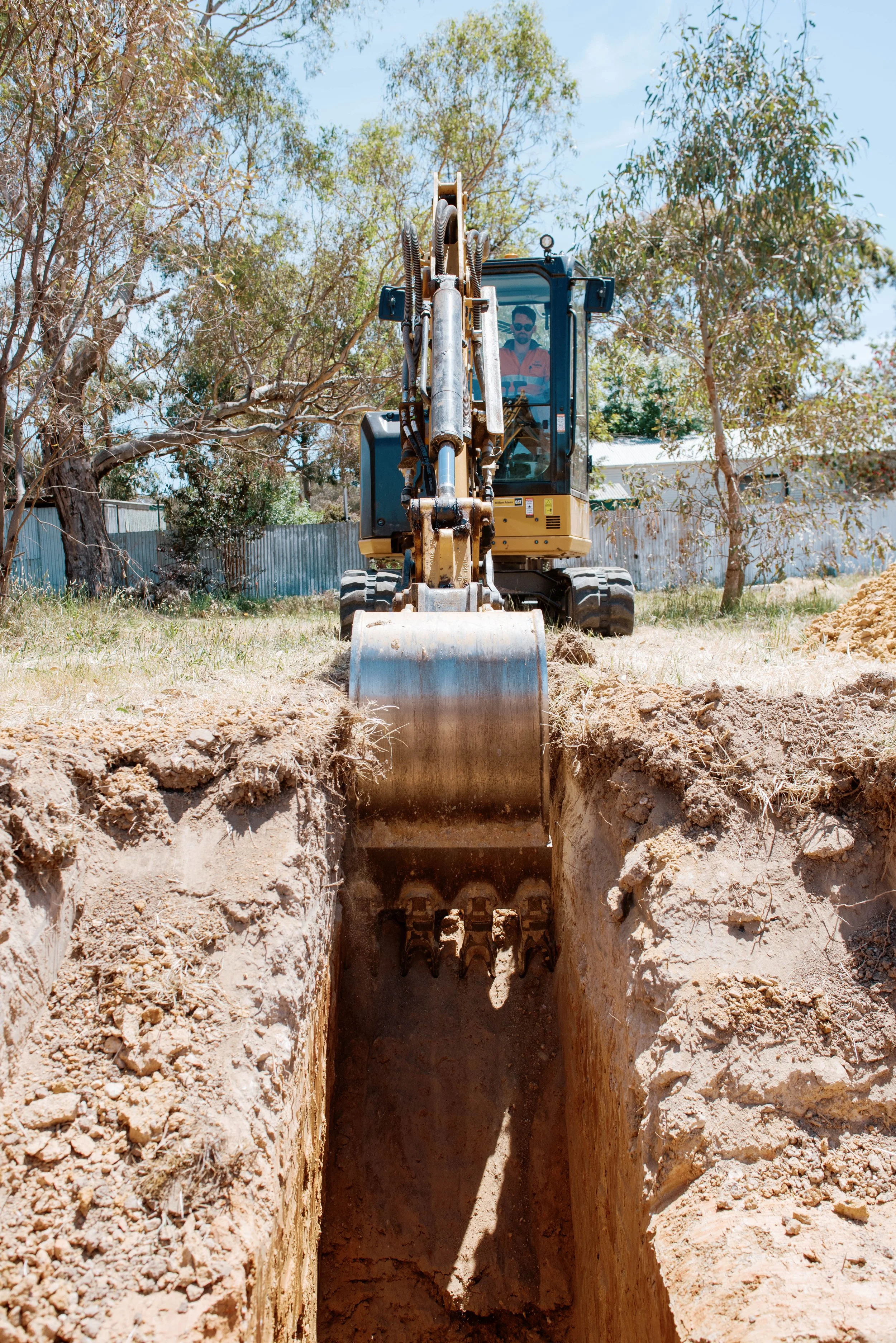 Excavator digging trench