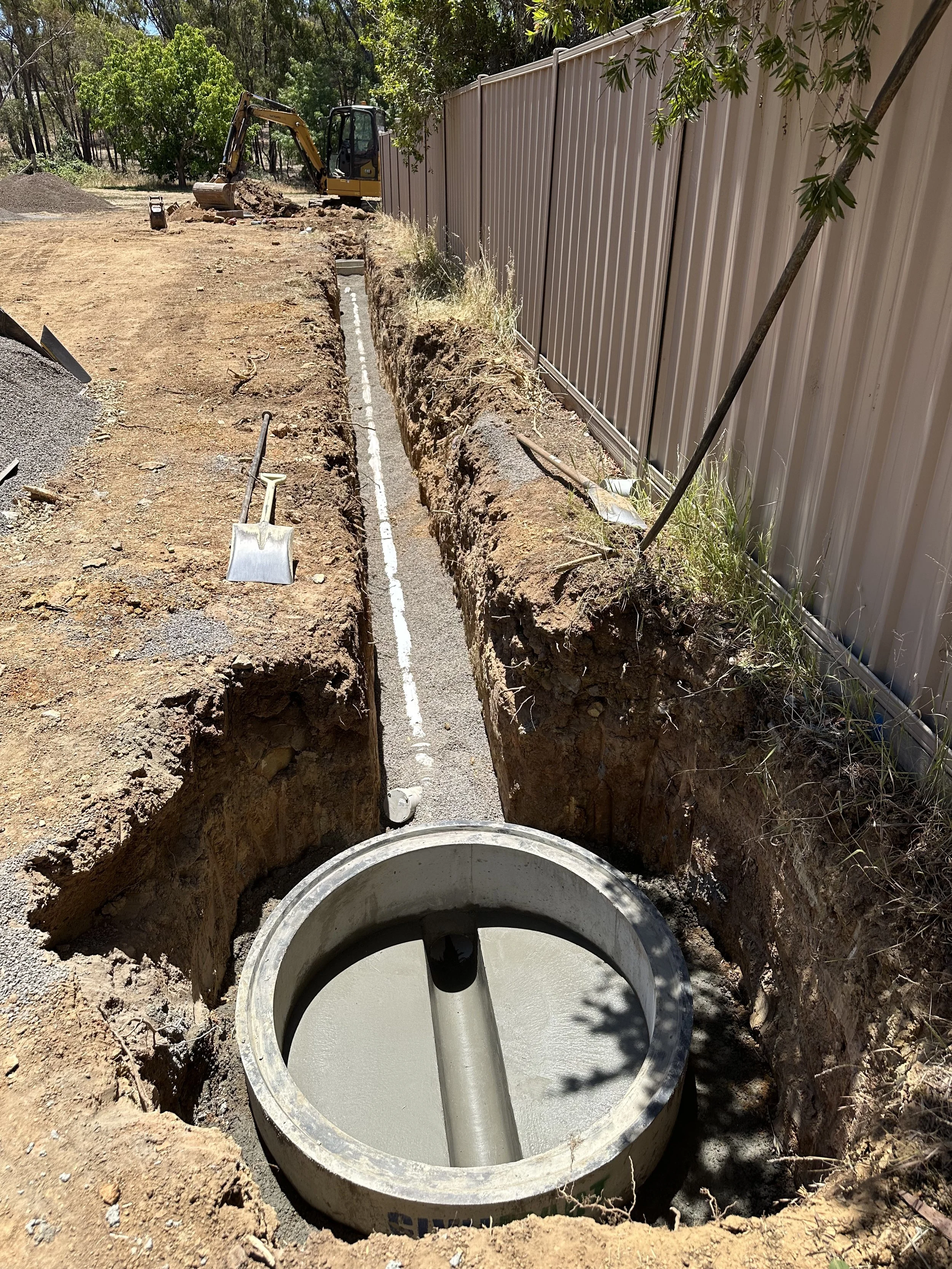 New sewer main extension with concrete manhole base