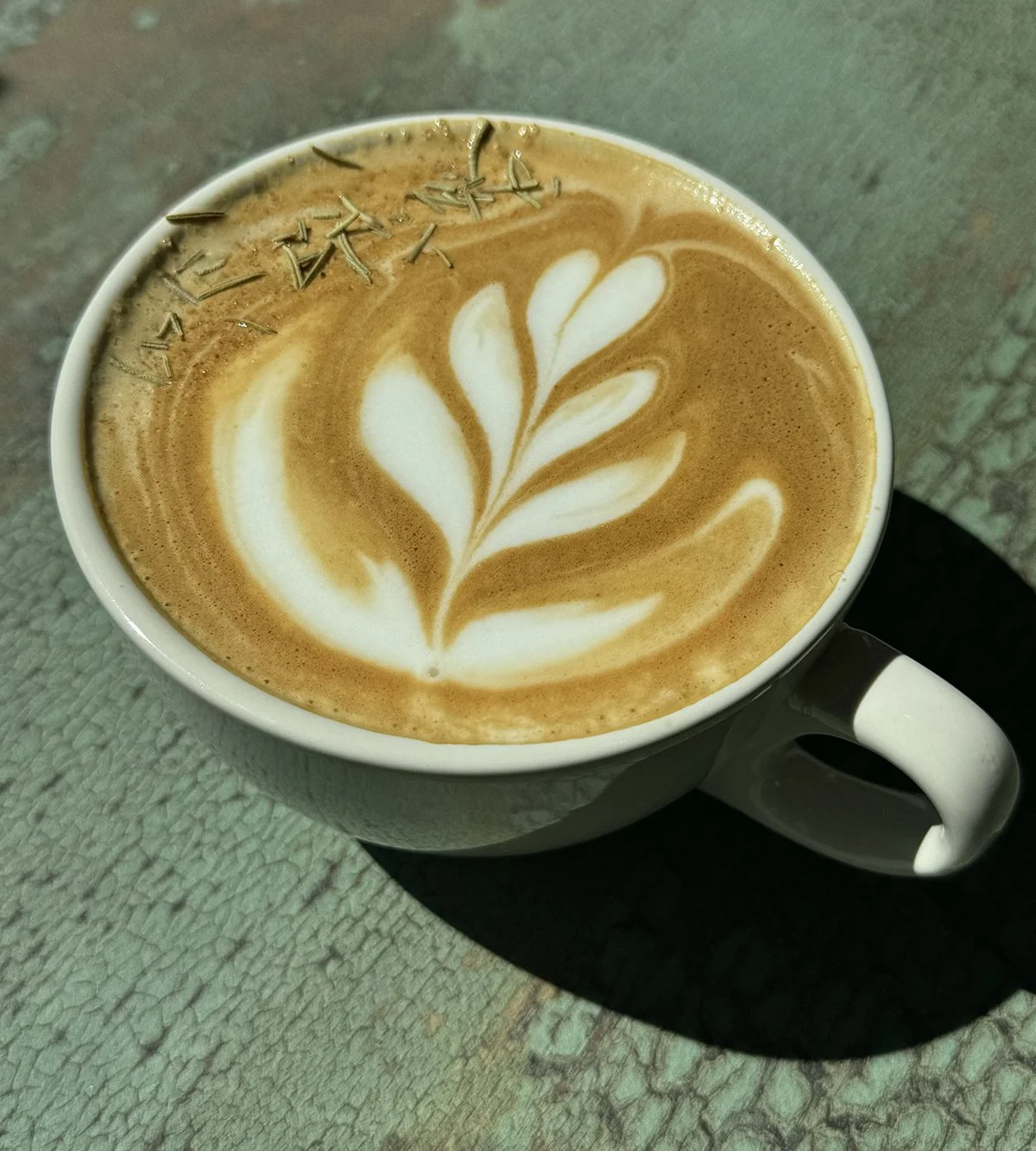 A hot latte with house made Rosemary syrup