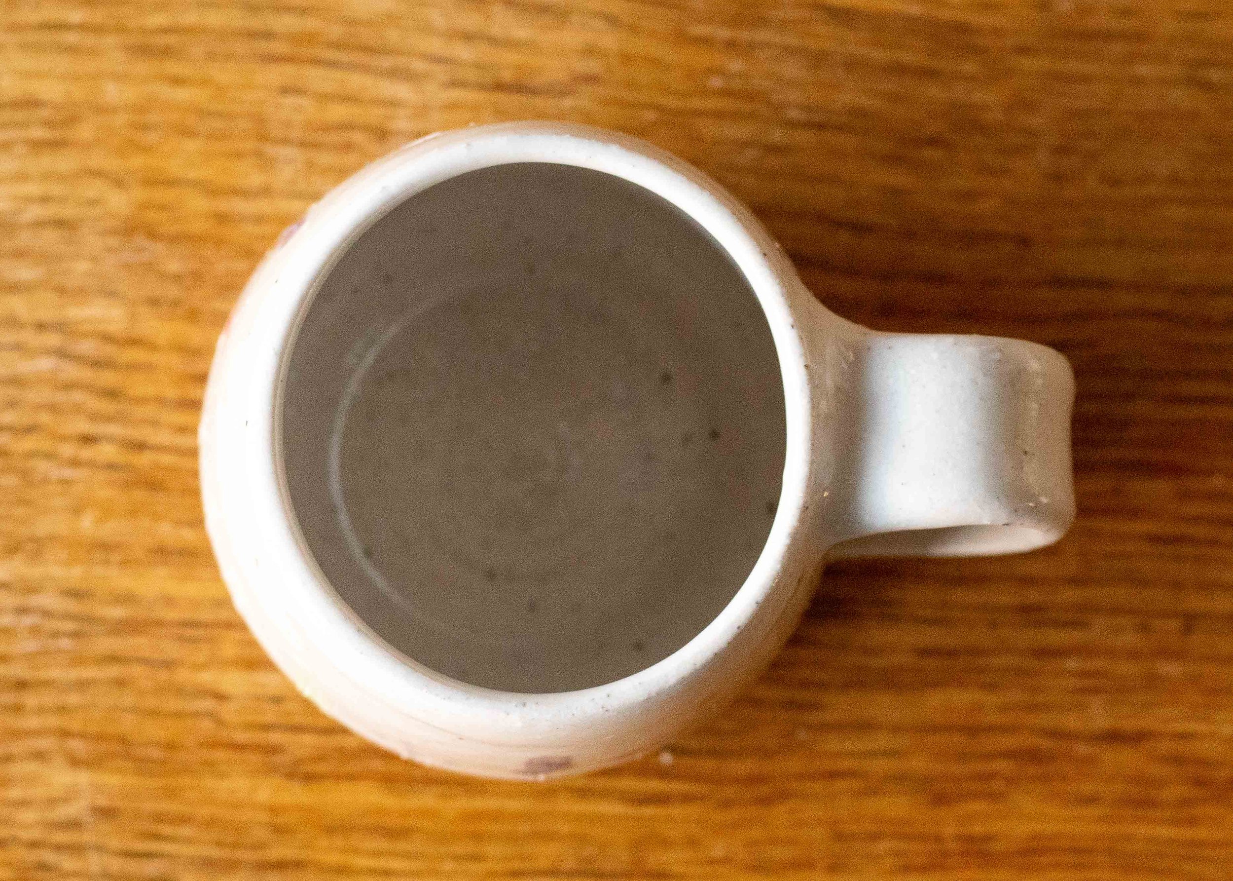 Small White Handmade Pottery Coffee Cup or Mug with Midsummer Flower Design