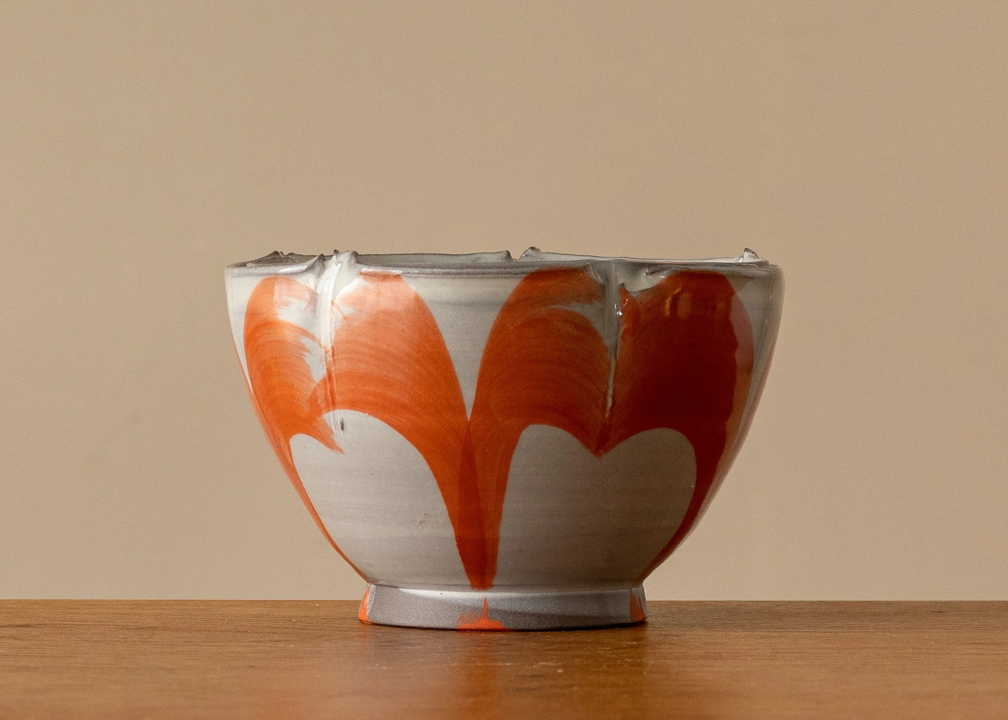 Small white thrown and altered bowl with brushed orange decoration.jpg