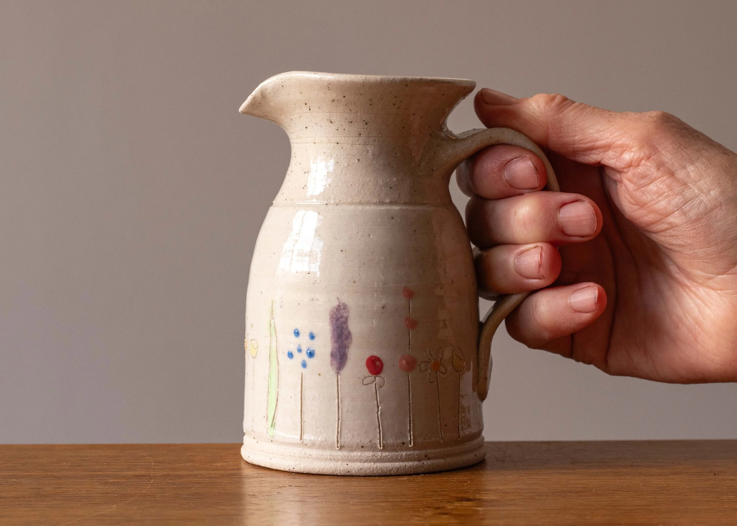 Midsummer Flowers Small Jug, with hand for scale.jpg