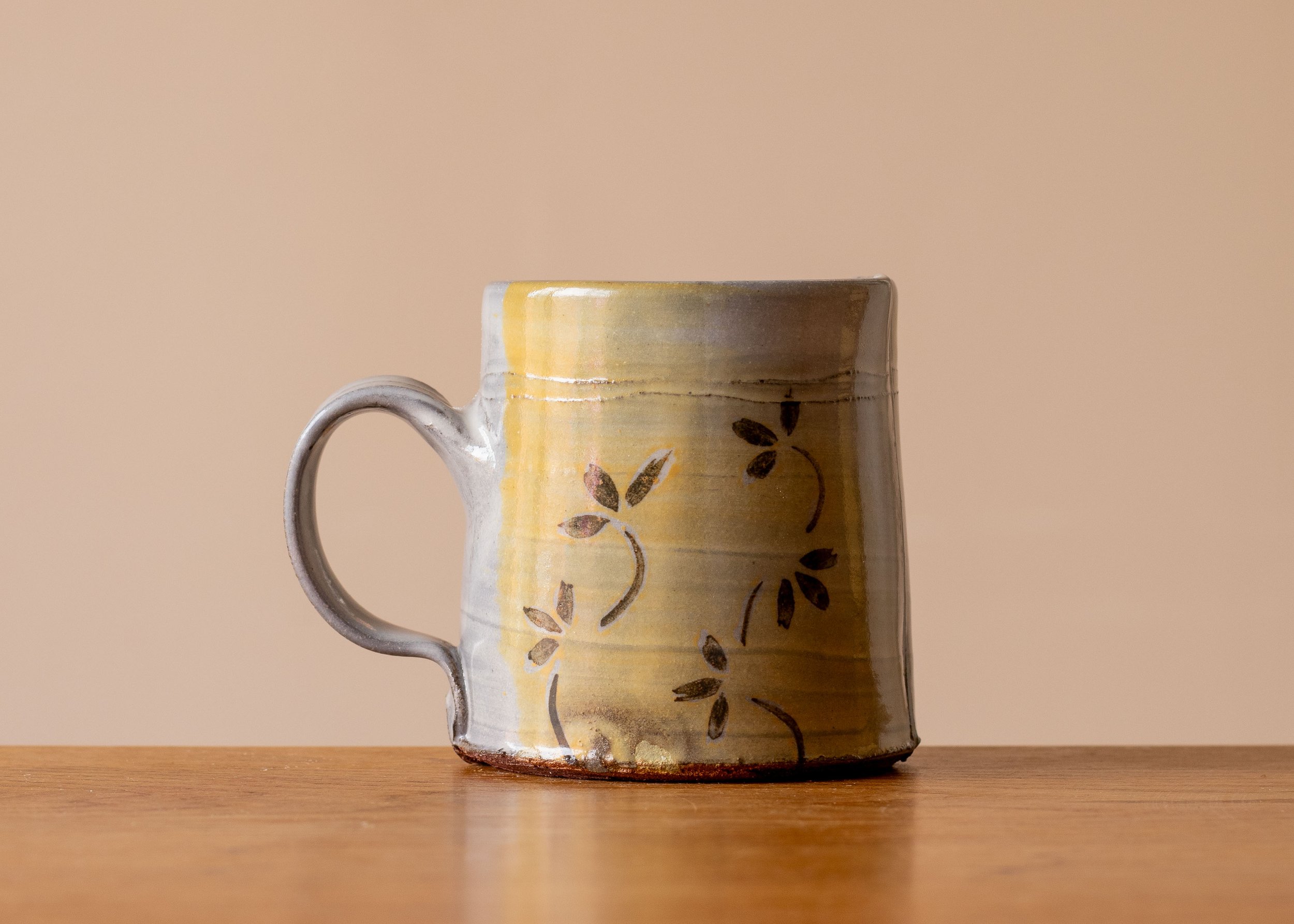 Handmade Pottery Mug with yellow and borwn autumn leaf decoration.jpg