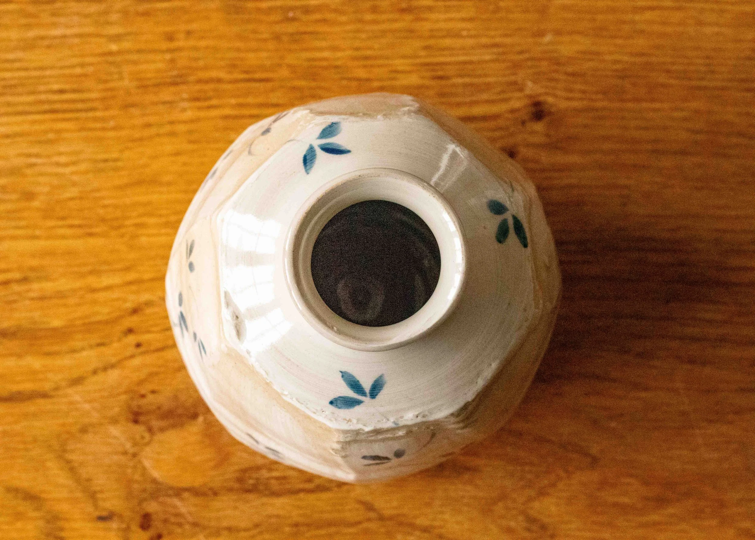Small blue and white faceted bottle with leaf design, view from above.jpg