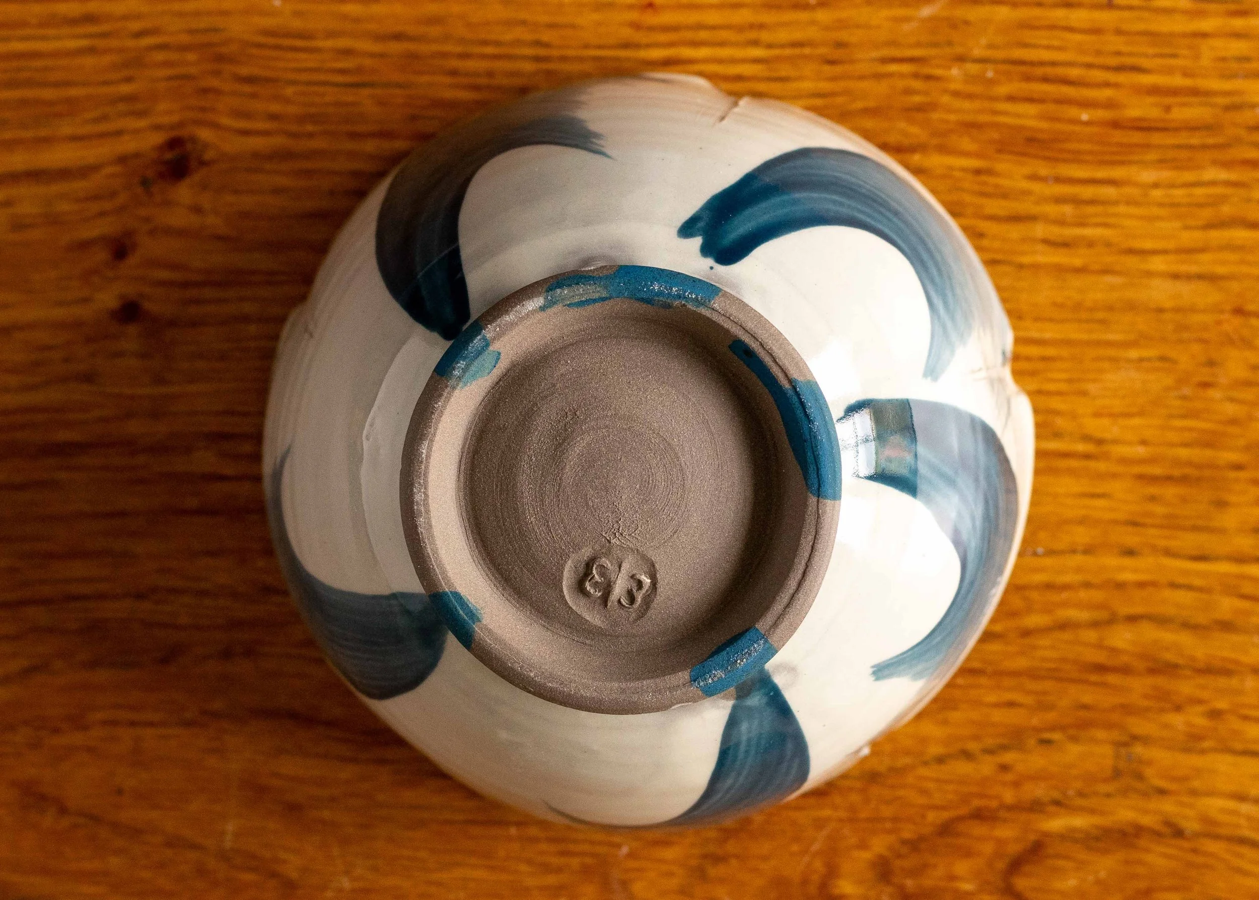 Handmade thrown and altered bowl with blue brushed decoration, view of the base.jpg