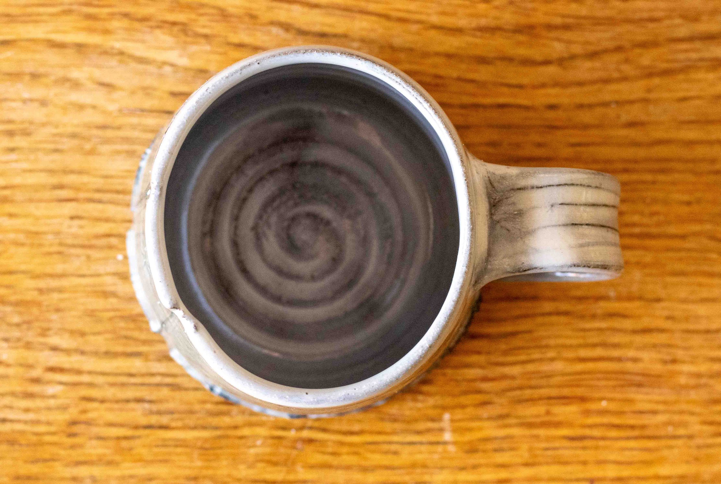 Handmade Pottery Coffee Cup with blue-green and impressed decoration, view from above.jpg