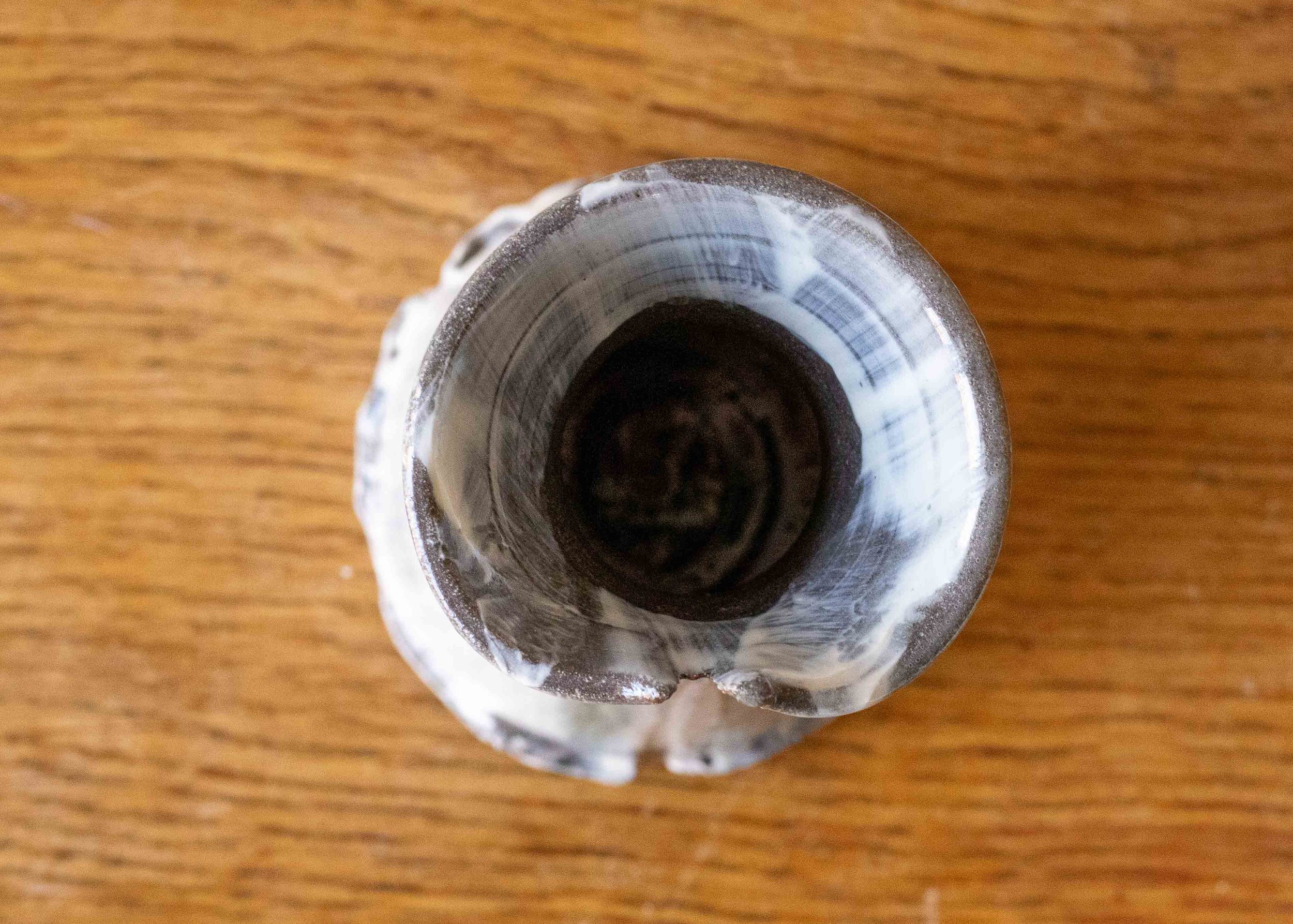 Small handmade stoneware vase with turquoise brushmarks, view from above.jpg