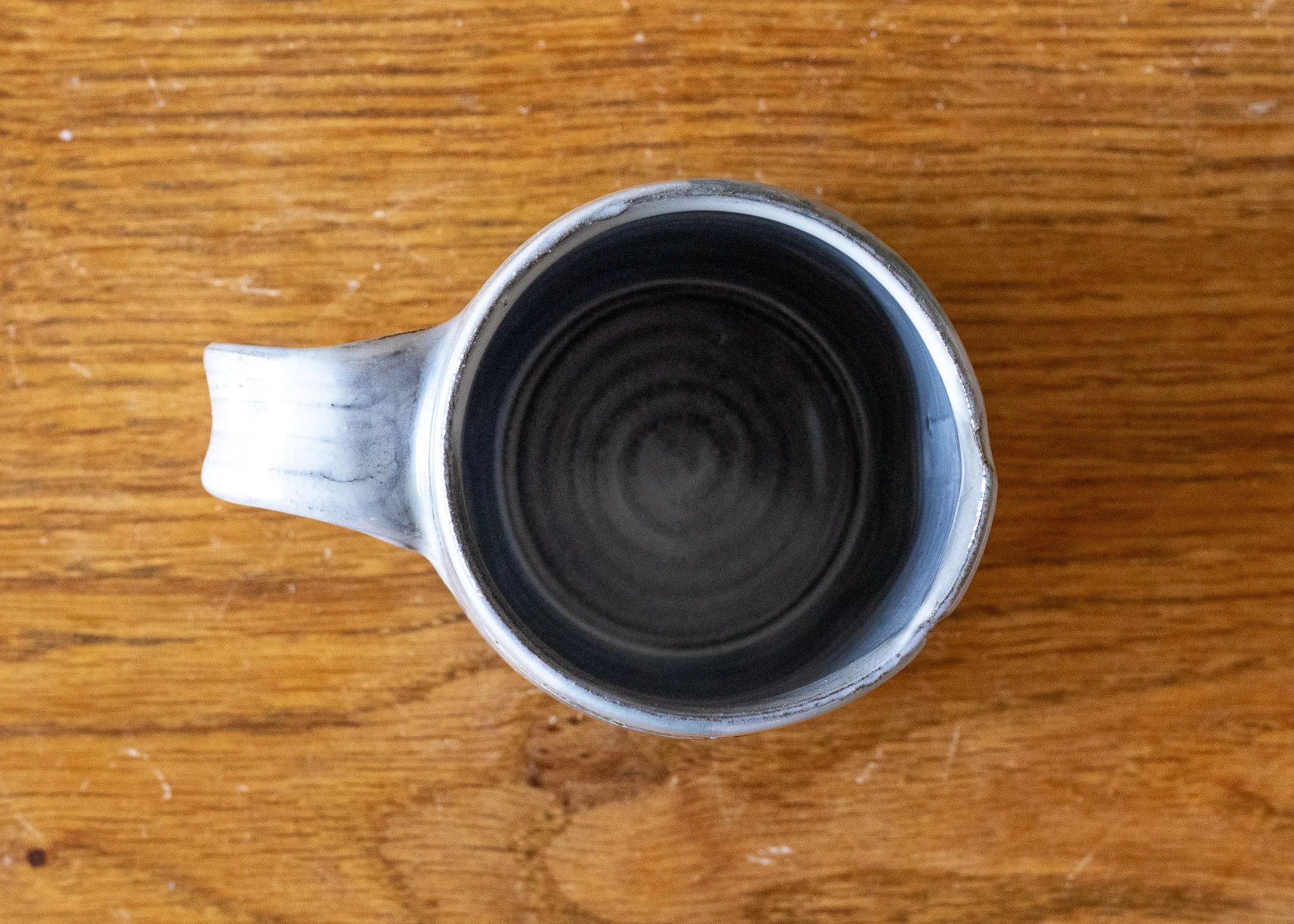 Small Handmade Pottery Coffee Cup with Turquoise Brushed Decoration, view from above.jpg