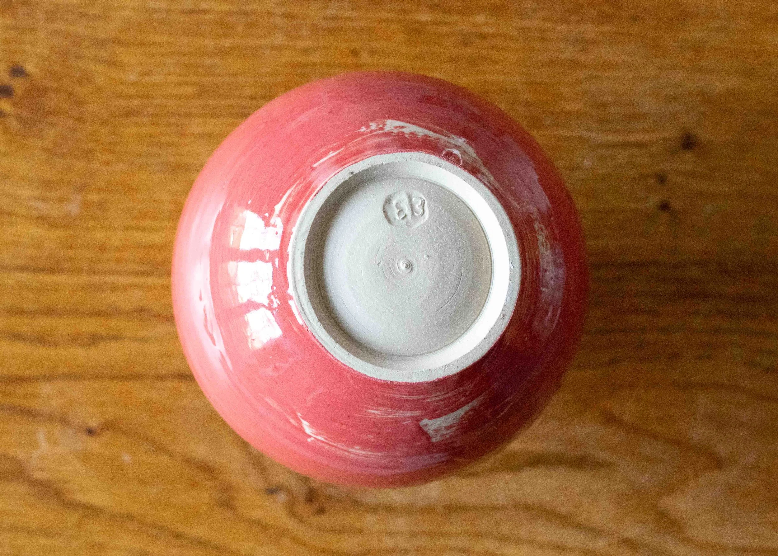 Medium Pale Red Moon Jar with White Decoration, view from below.jpg