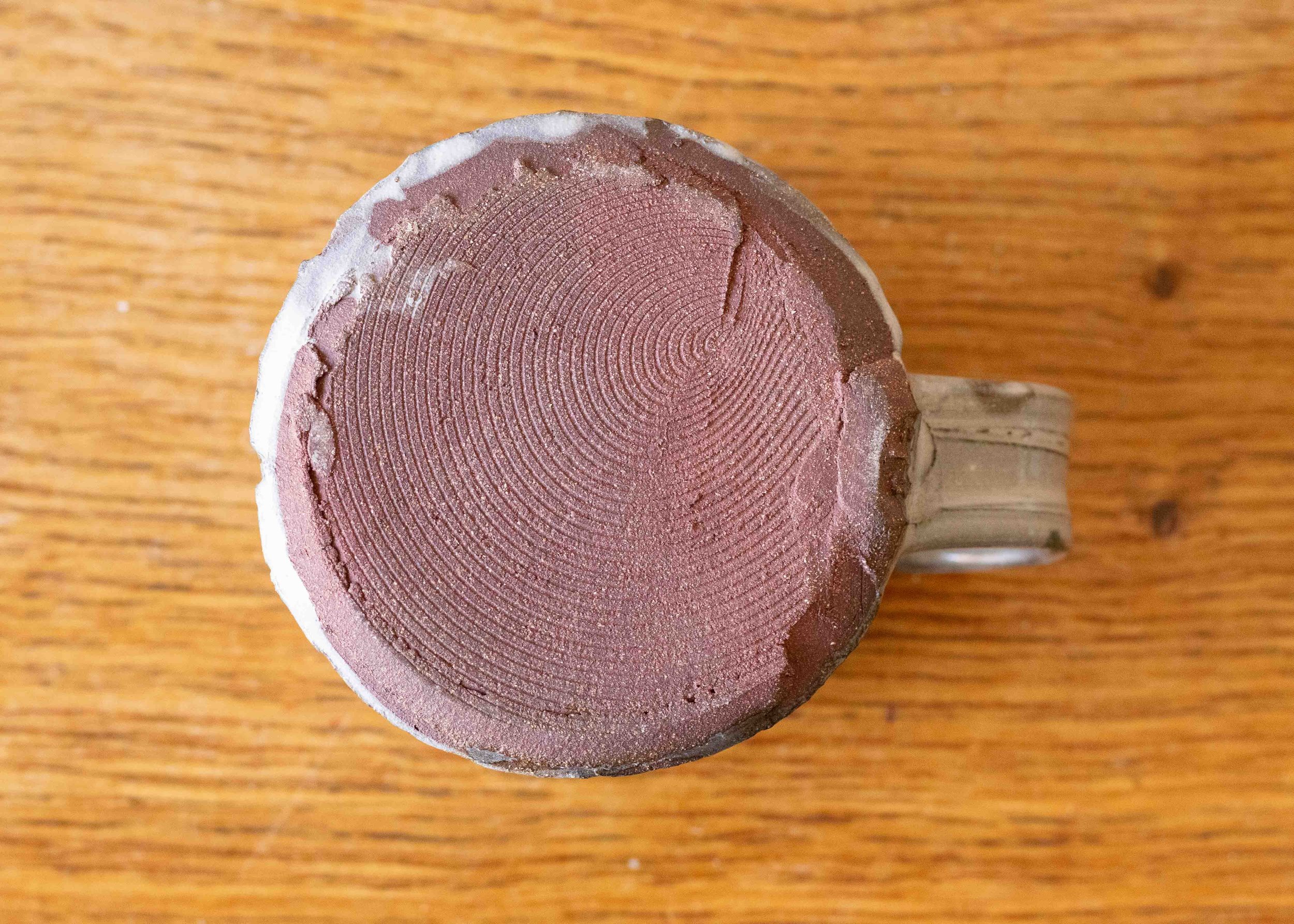 Handmade Pottery Coffee Cup with blue-green and impressed decoration, view of the base.jpg