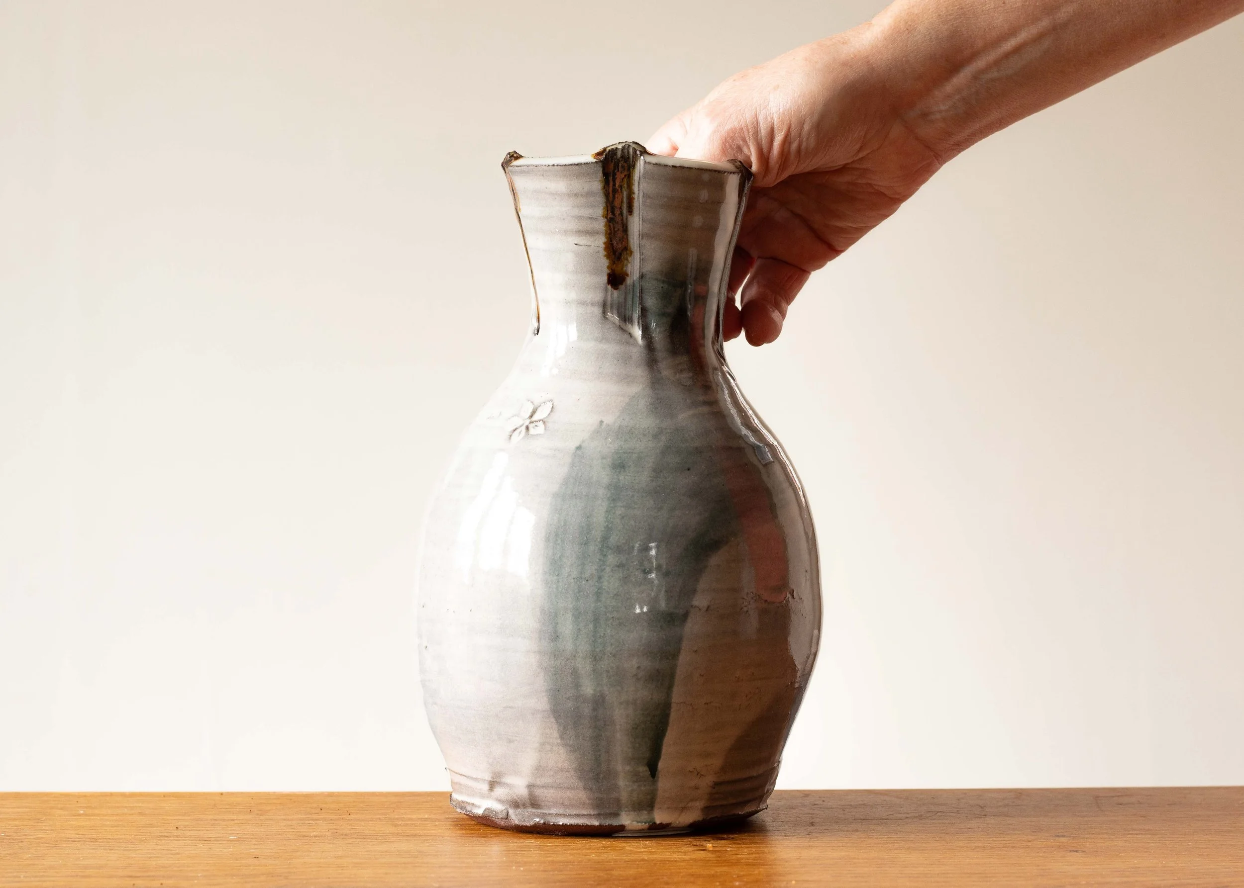 Handmade Pottery Vase with Green Brush Marks, with hand for scale.jpg