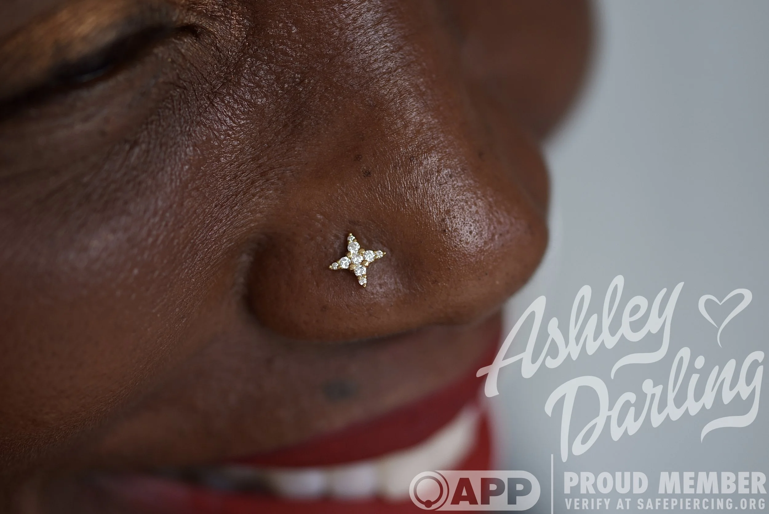 Close-up of a person's nose with a star-shaped diamond stud nose jewelry.