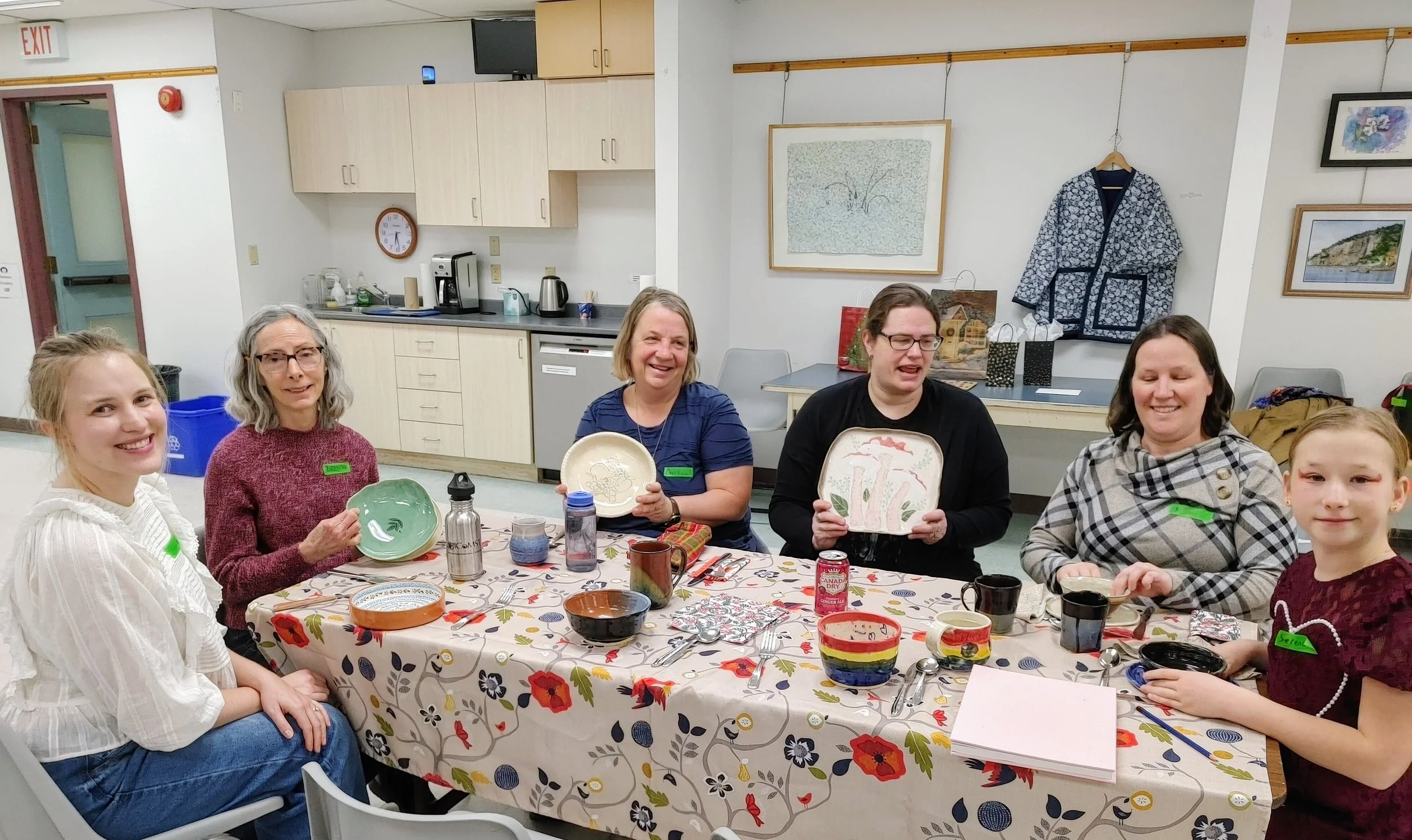 Potluck 2025- Vendela, Brenda, Caroline, Kelly, Melissa and Serena, showing off the pottery dishes that they brough to eat from!
