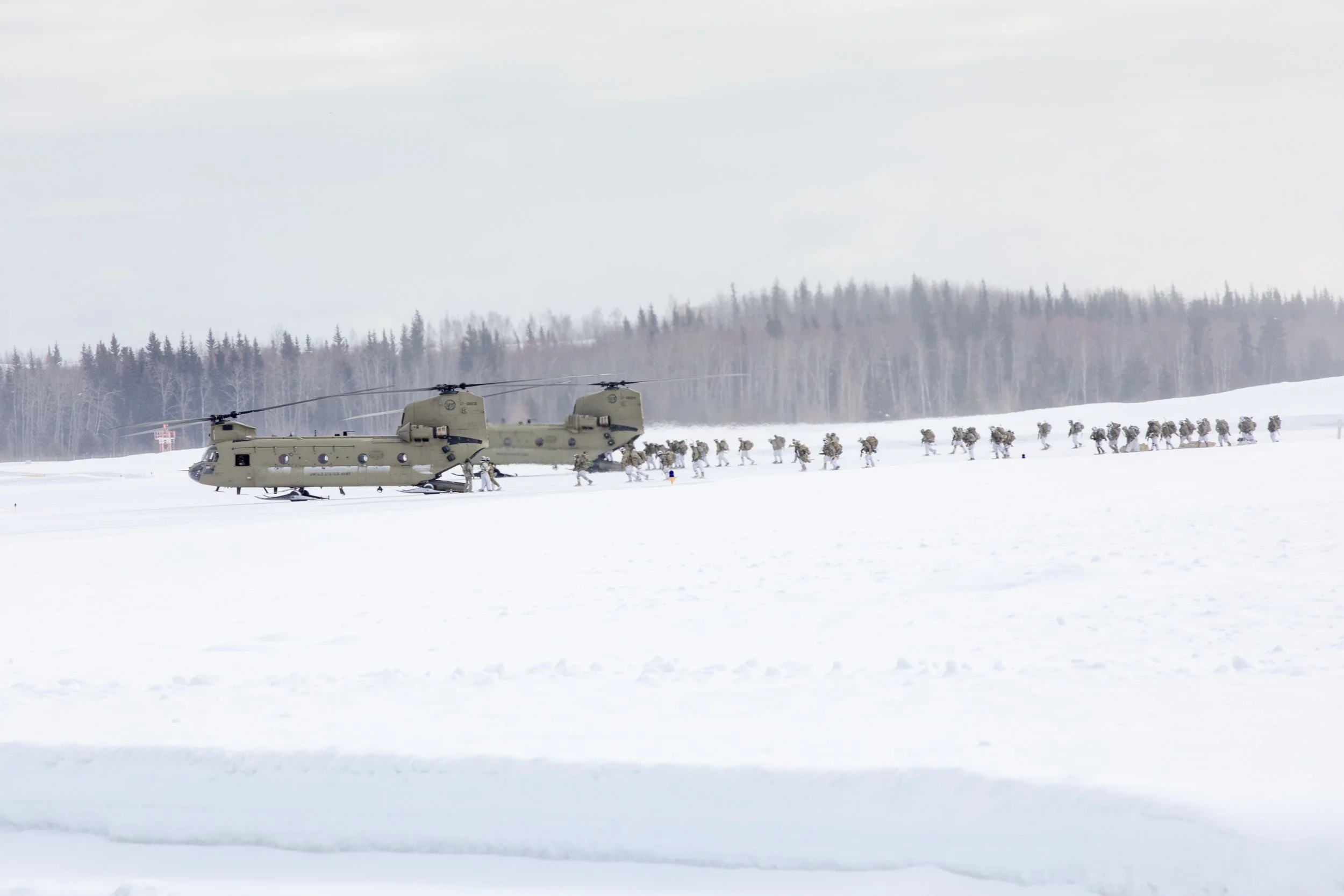 11th Airborne Division Soldiers load up on to two CH-47 Chinooks during  Joint Pacific Multinational Readiness Center training in 2023