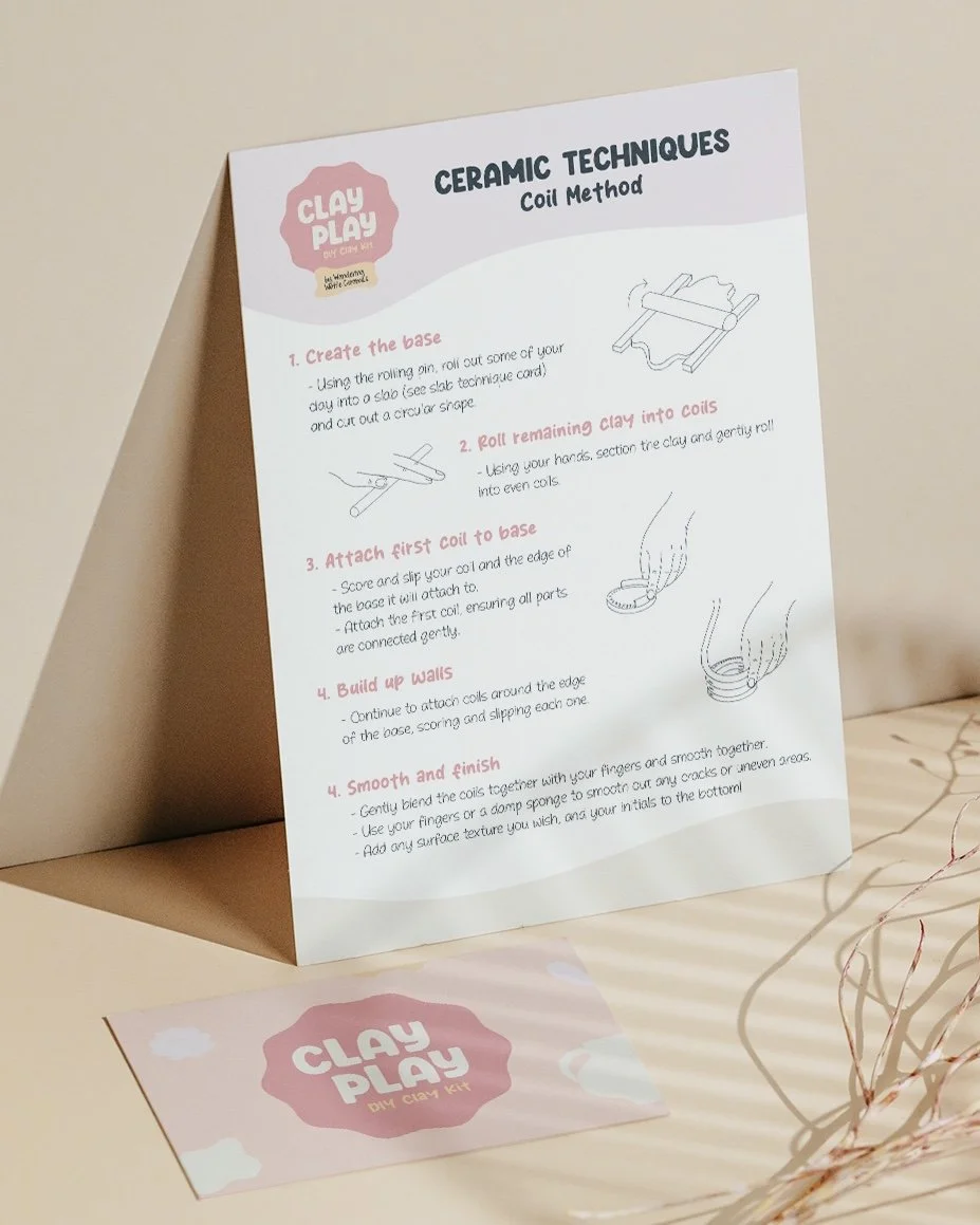Instruction sheet for ceramic clay coil technique with illustrations, branded 'Clay Play DIY Clay Kit', placed on a table with a pink card that also says 'Clay Play' and some decorative wire.