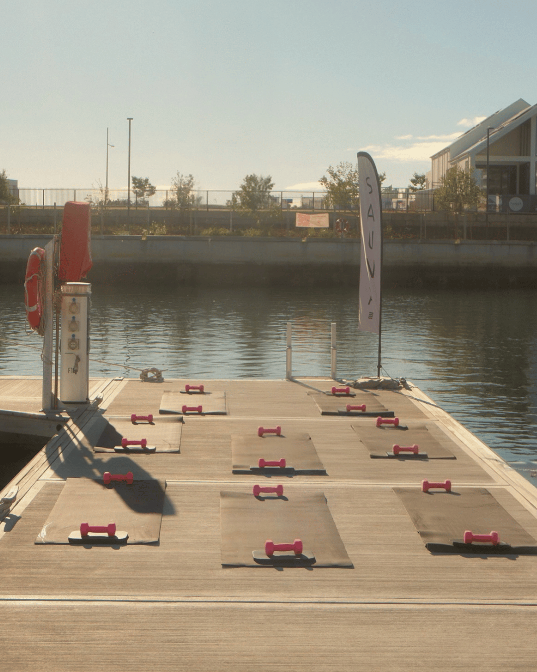 Pilates mats set up by the dock at the marina