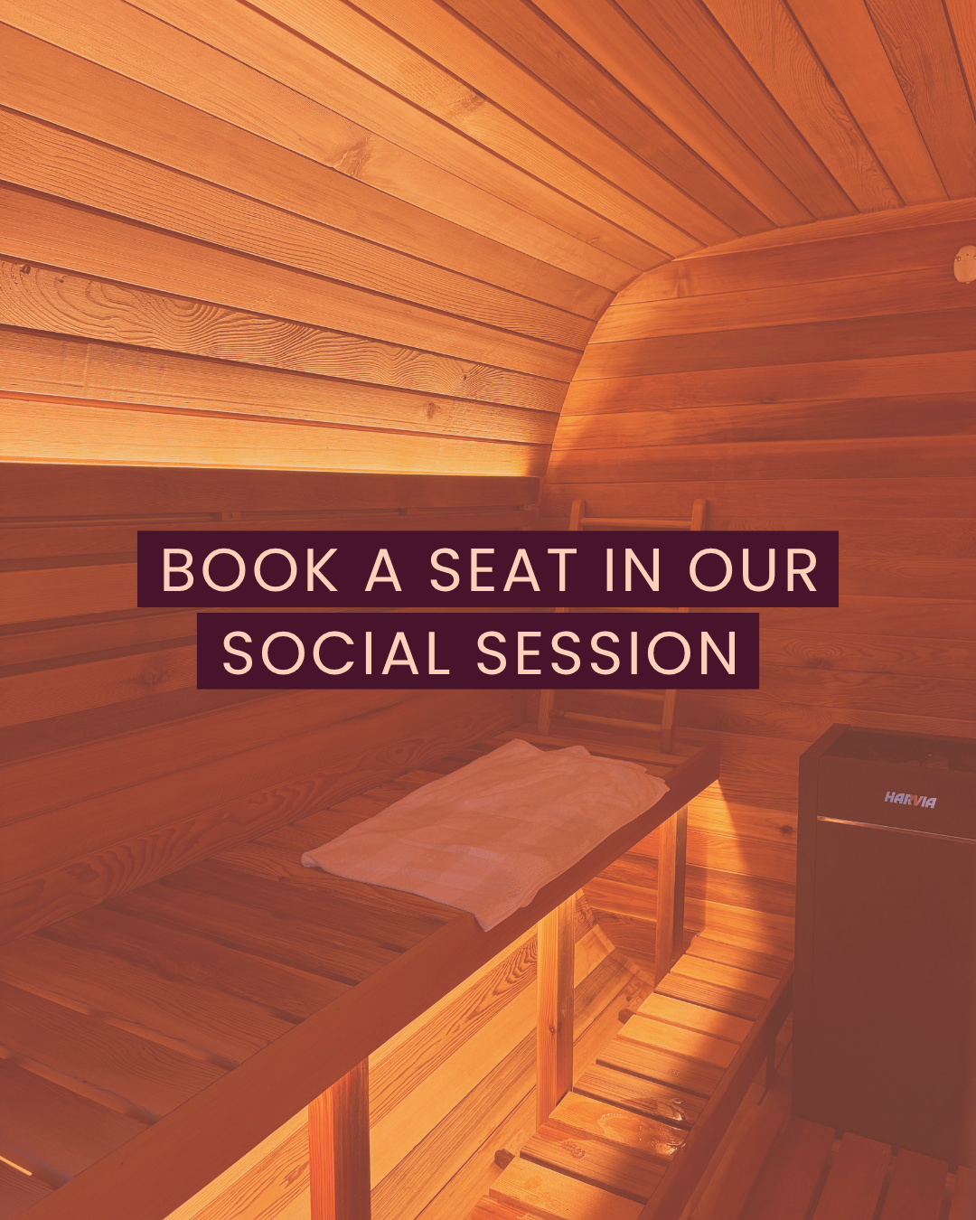 Wooden sauna room with a bench, towel, and a small refrigerator.