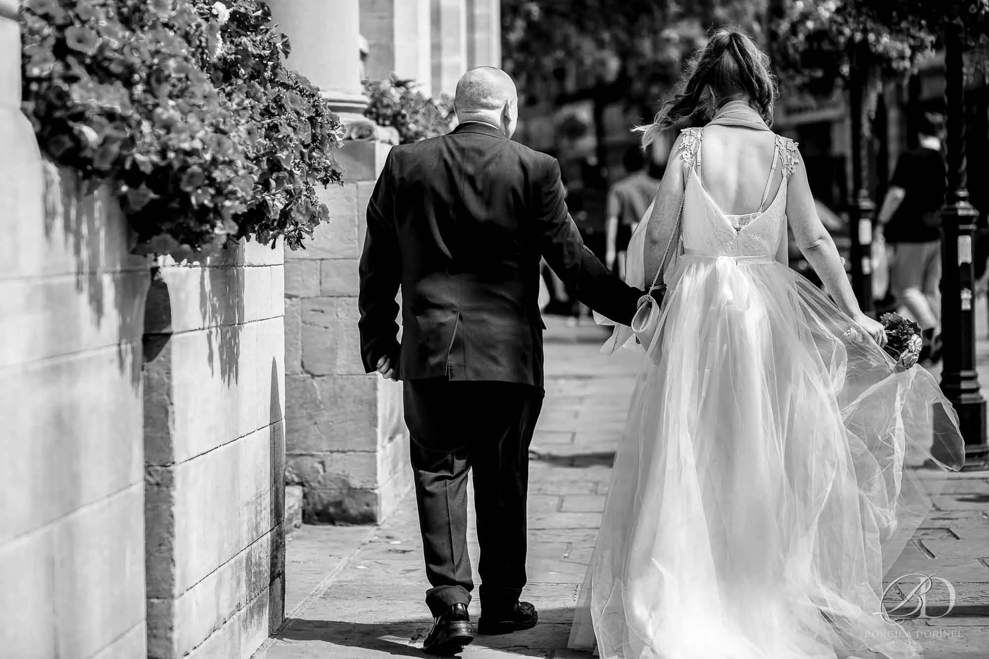 Editorial photography with a bride and groom walking from the back.