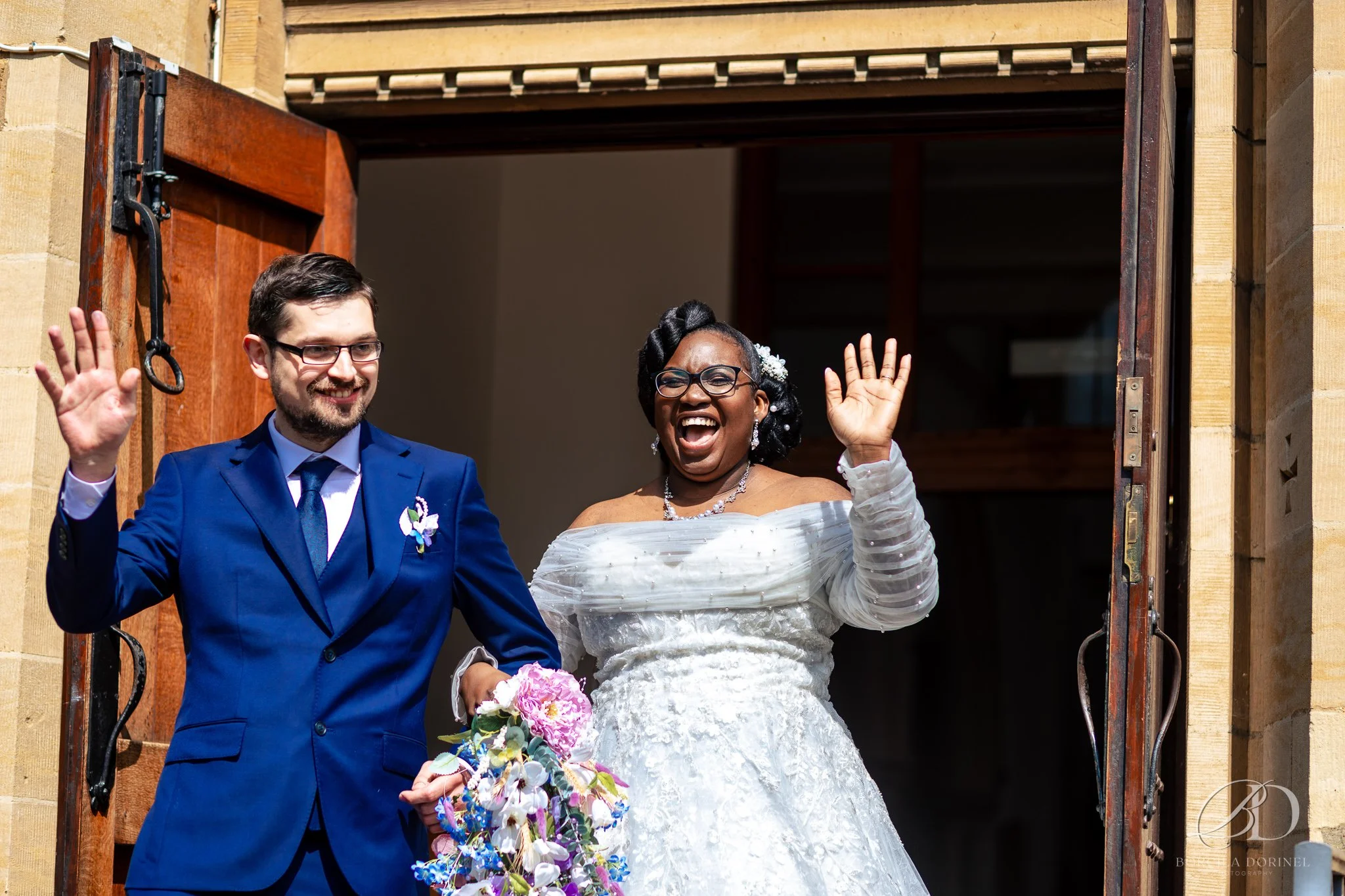Natural storytelling wedding photography of couple surrounded by guests
