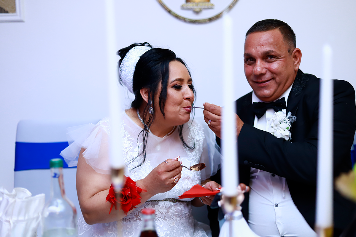 bride and groom eating cake.png
