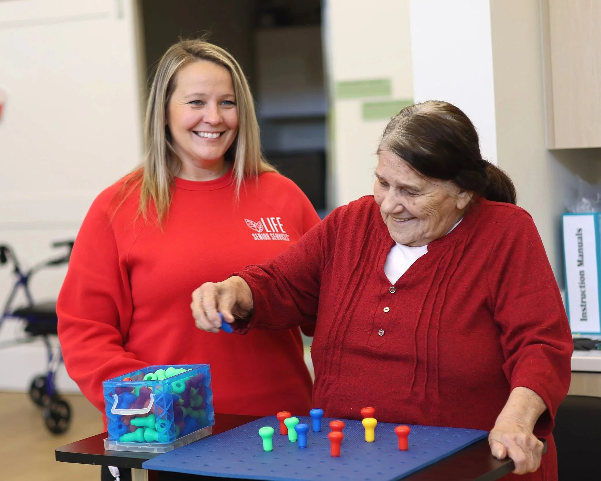 Spacious rehabilitation gym with exercise equipment, therapy beds, stationary bikes, and open space for mobility exercises.