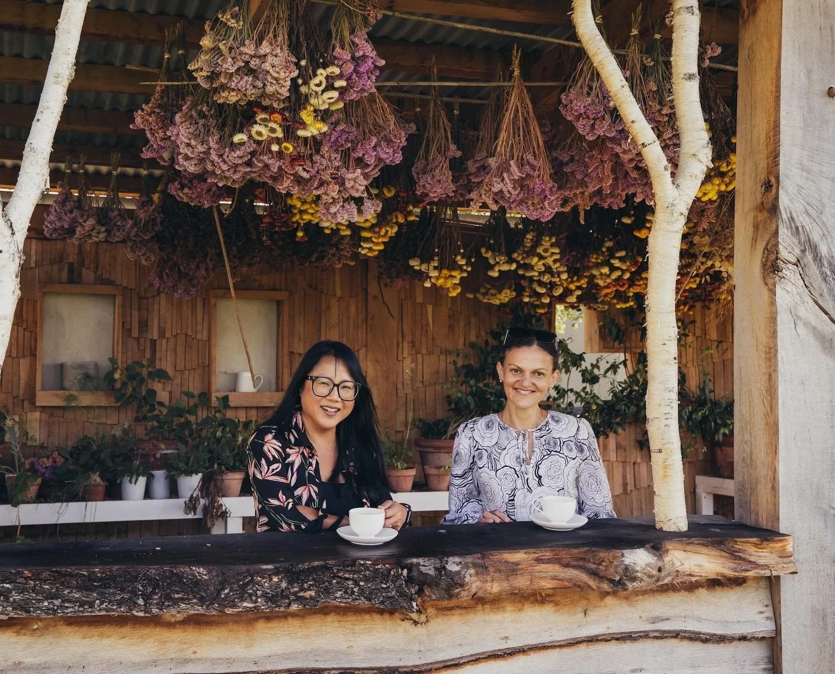 Two women smiling and drinking coffee