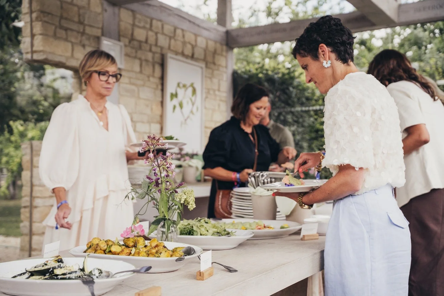 People serving themselves food at the VIP influencer launch at a She's Electric with Volvo