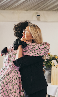 Bex, CEO hugging Erin Baker