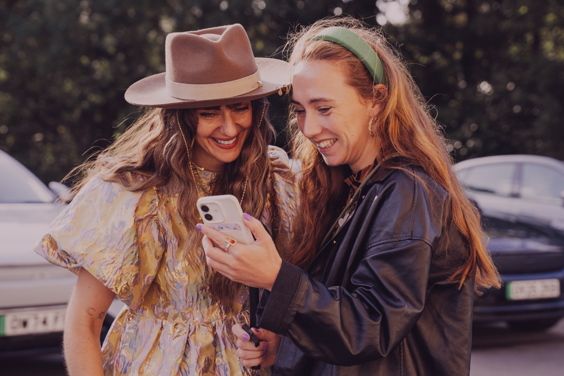 Two women smiling at a phone