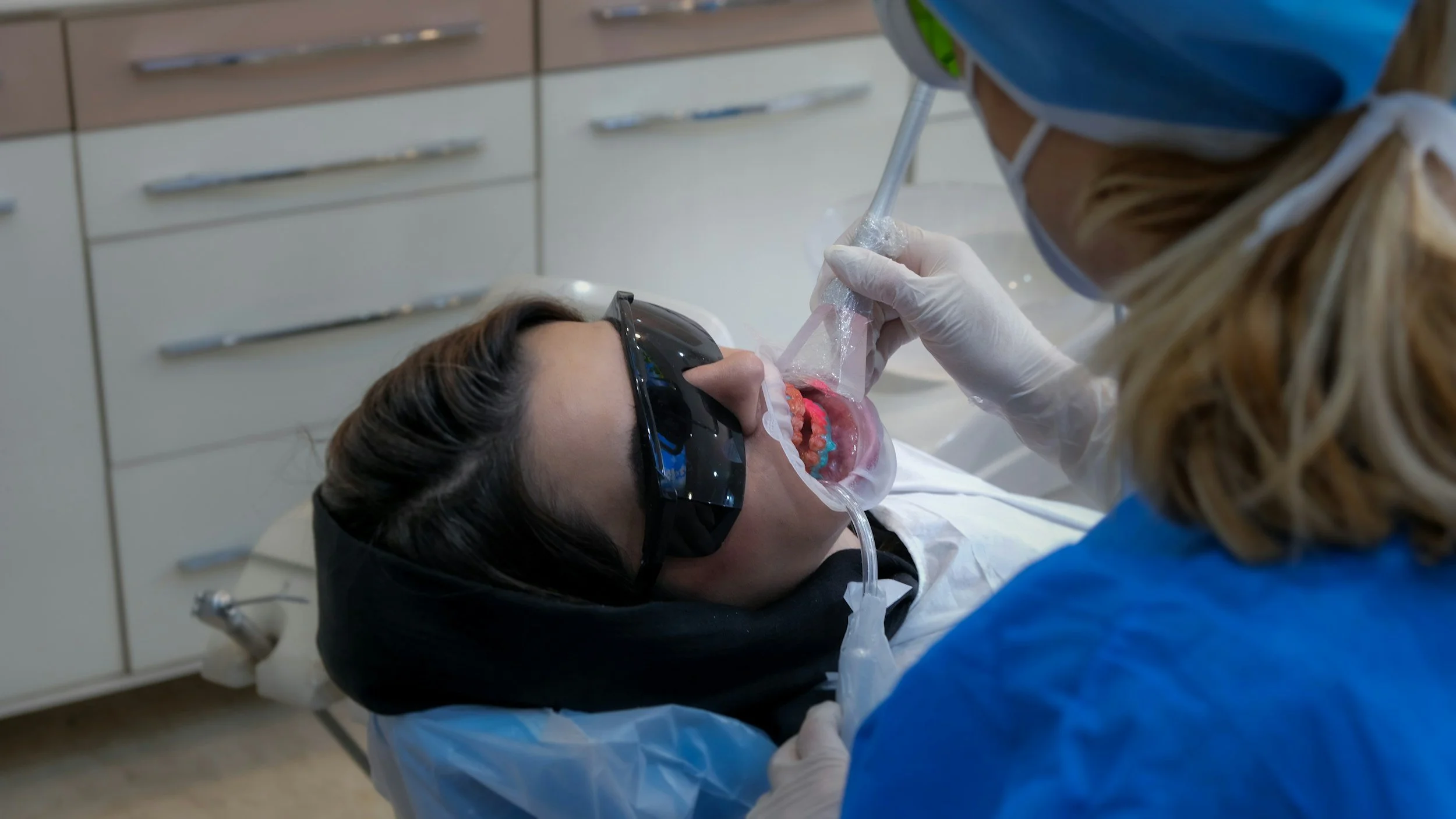 Dr. Hernandez with patient in teeth whitening